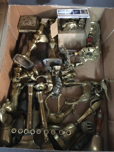 A box of brass candle sticks and other oddments, cast iron pig door stop