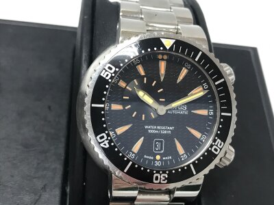 Oris Divers Small Second Date watch, featuring a 47mm stainless steel case and a black dial with distinct orange accents. Inner box. Seen running.