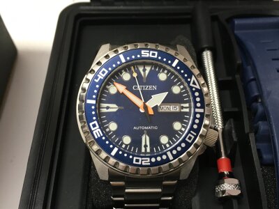 A Citizen automatic sports diver style watch with blue dial. Comes with case and the original accessories. Seen running.