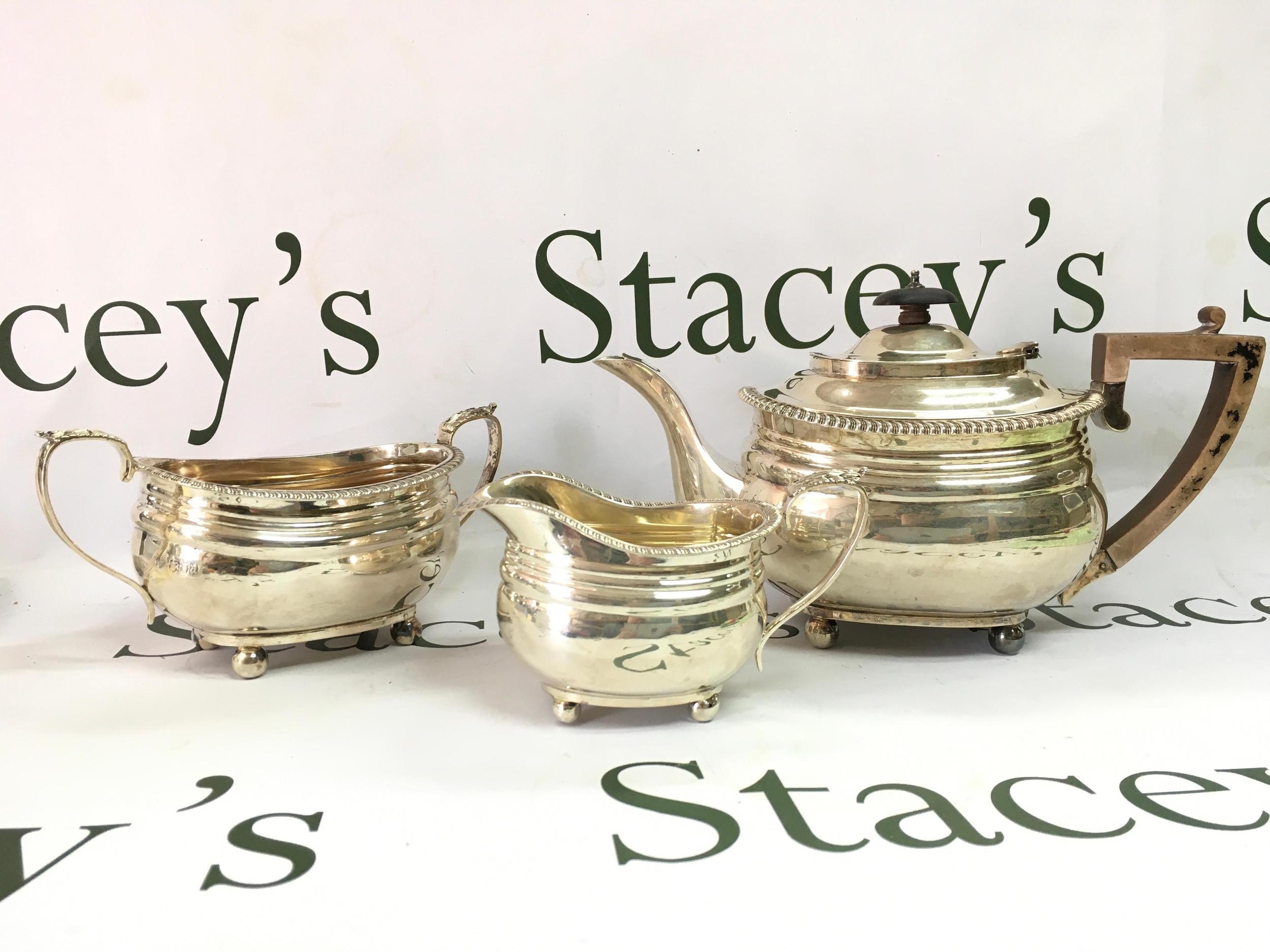 A three piece silver tea set. 1916 London hallmarks. 10 to 17cm tall. 1085g total weight. Marked at base Goldsmiths & Silversmith company 112 Regent Street.W
