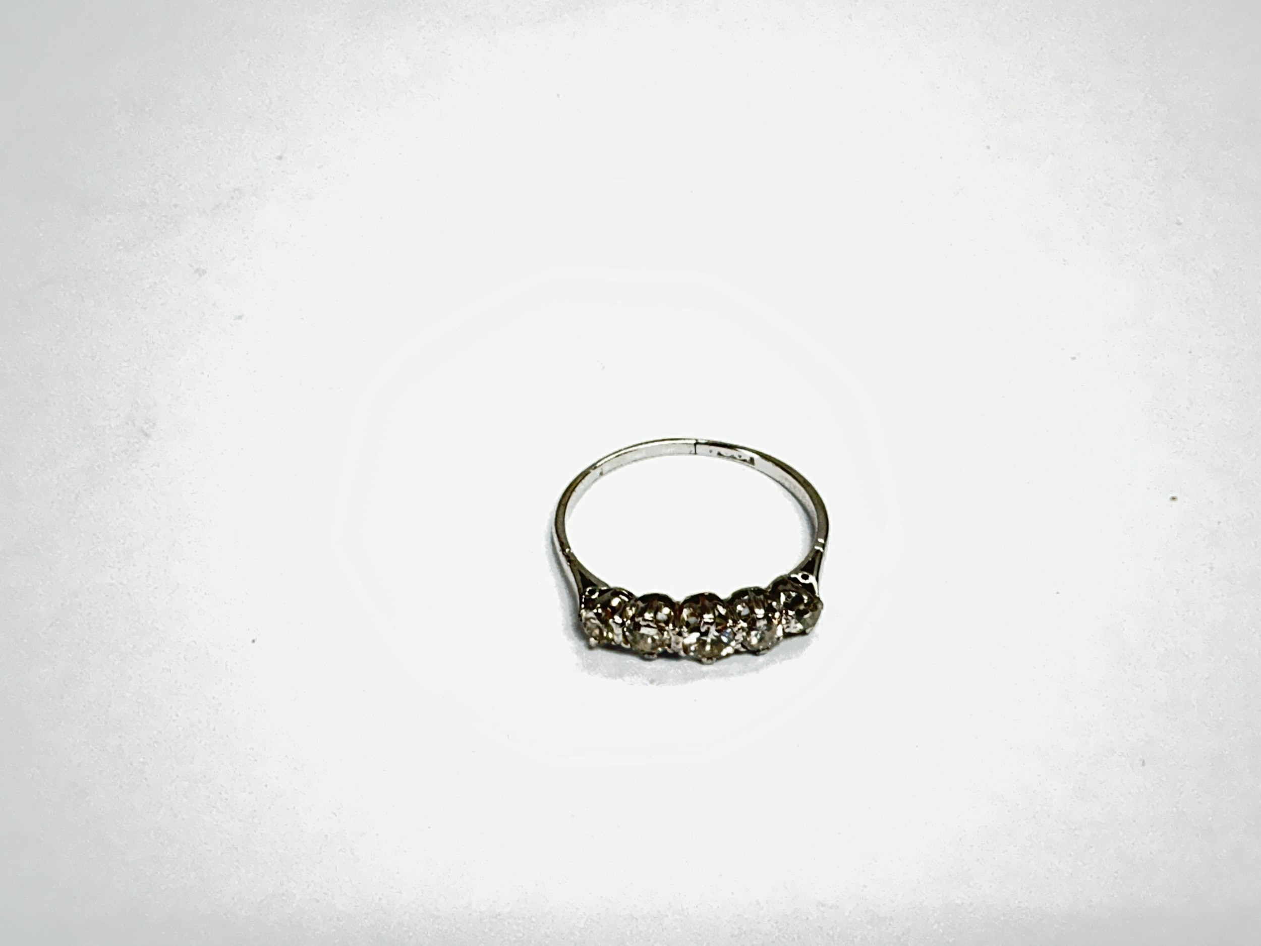 An 18ct white gold ring set with a row of five diamonds, approx 1.6g and approx size P-Q.