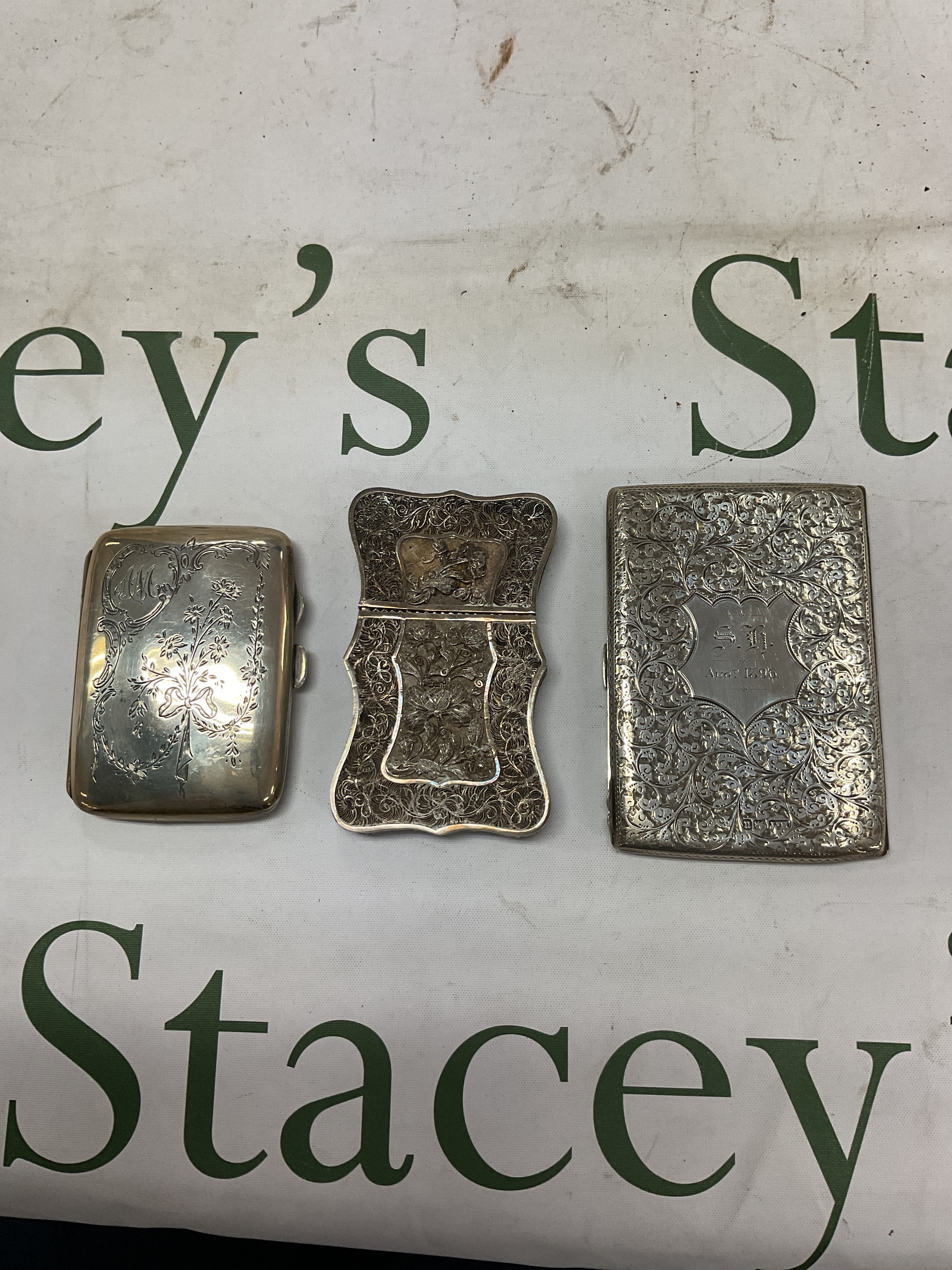 Three HM silver cigarette cases to include Victorian example and Chinese filigree example .weight 170 grams.