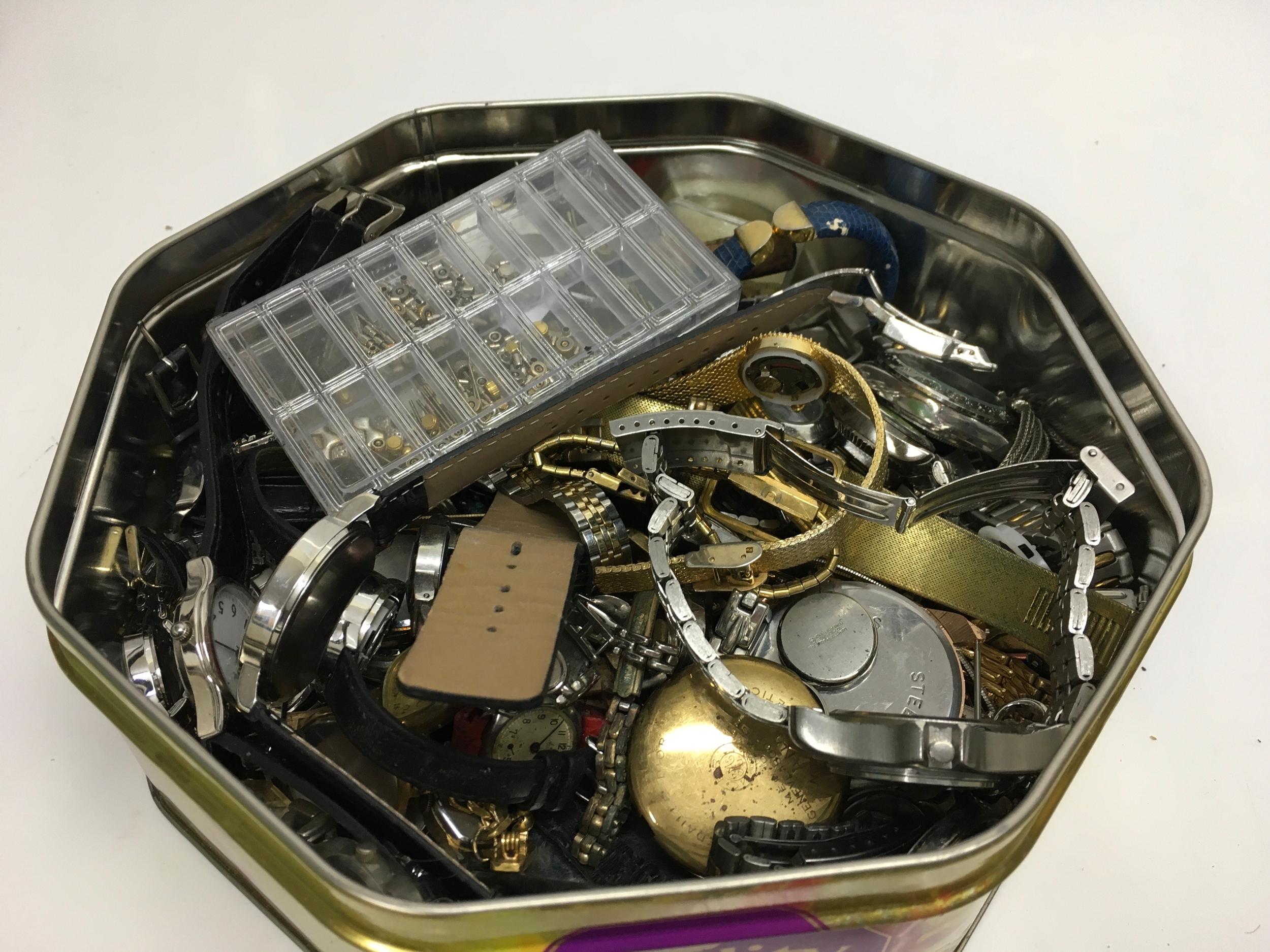 A collection of dress wristwatches and spare parts