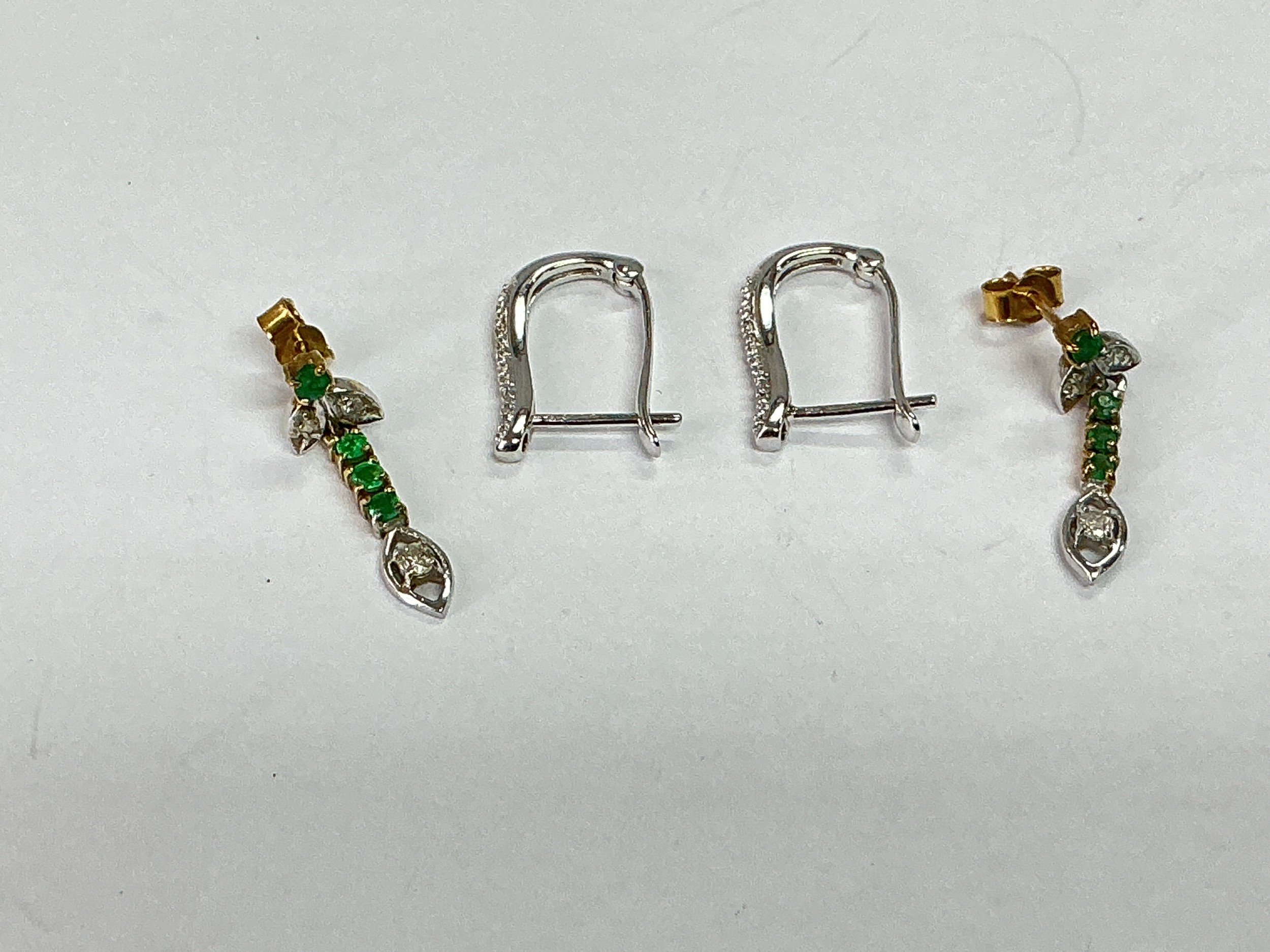 A pair of 18ct white gold earrings together with another pair set with diamonds and emeralds, total weight approx 3.6g.