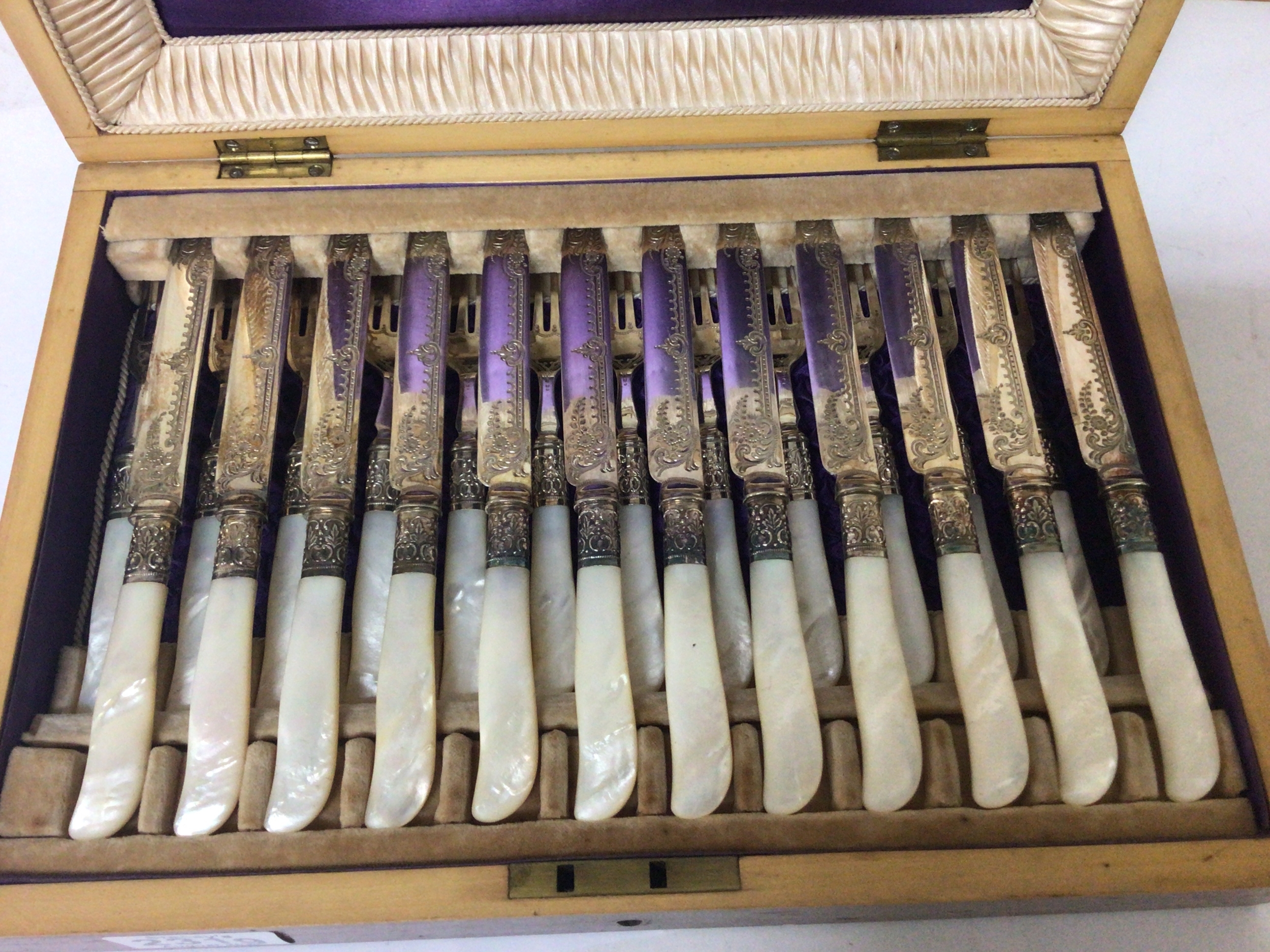  A Quality set of silver plated and mother of pearl desert kinifes and folks with elaborate engraved blades in a nice fitted box 