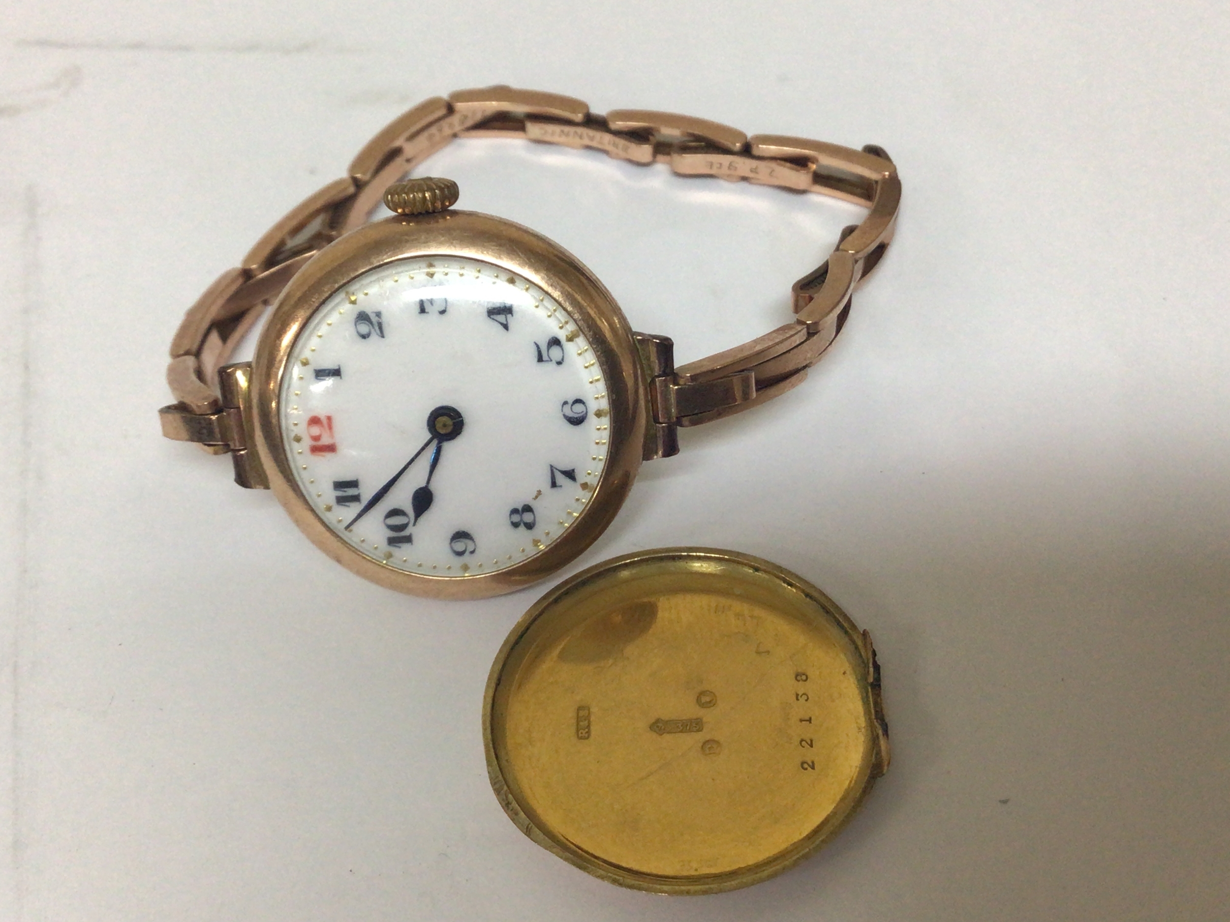  A 9carat gold ladies wrist watch with an expanding bracelet the back plate detached from the watch. 