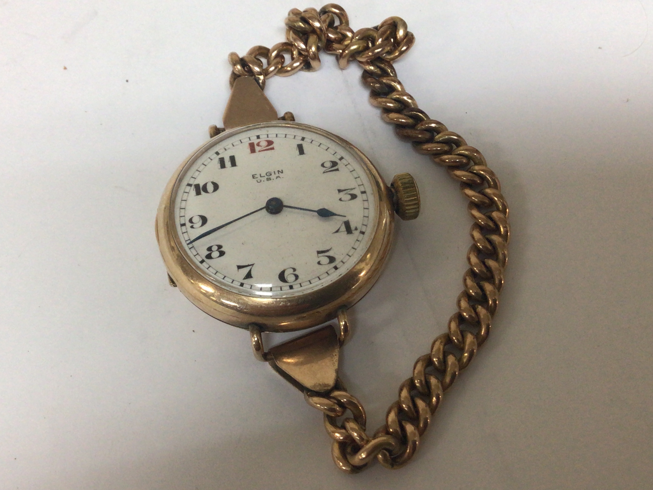   A gold plated Vintage ladies watch Elgin with an attached unmarked yellow metal open link bracelet 