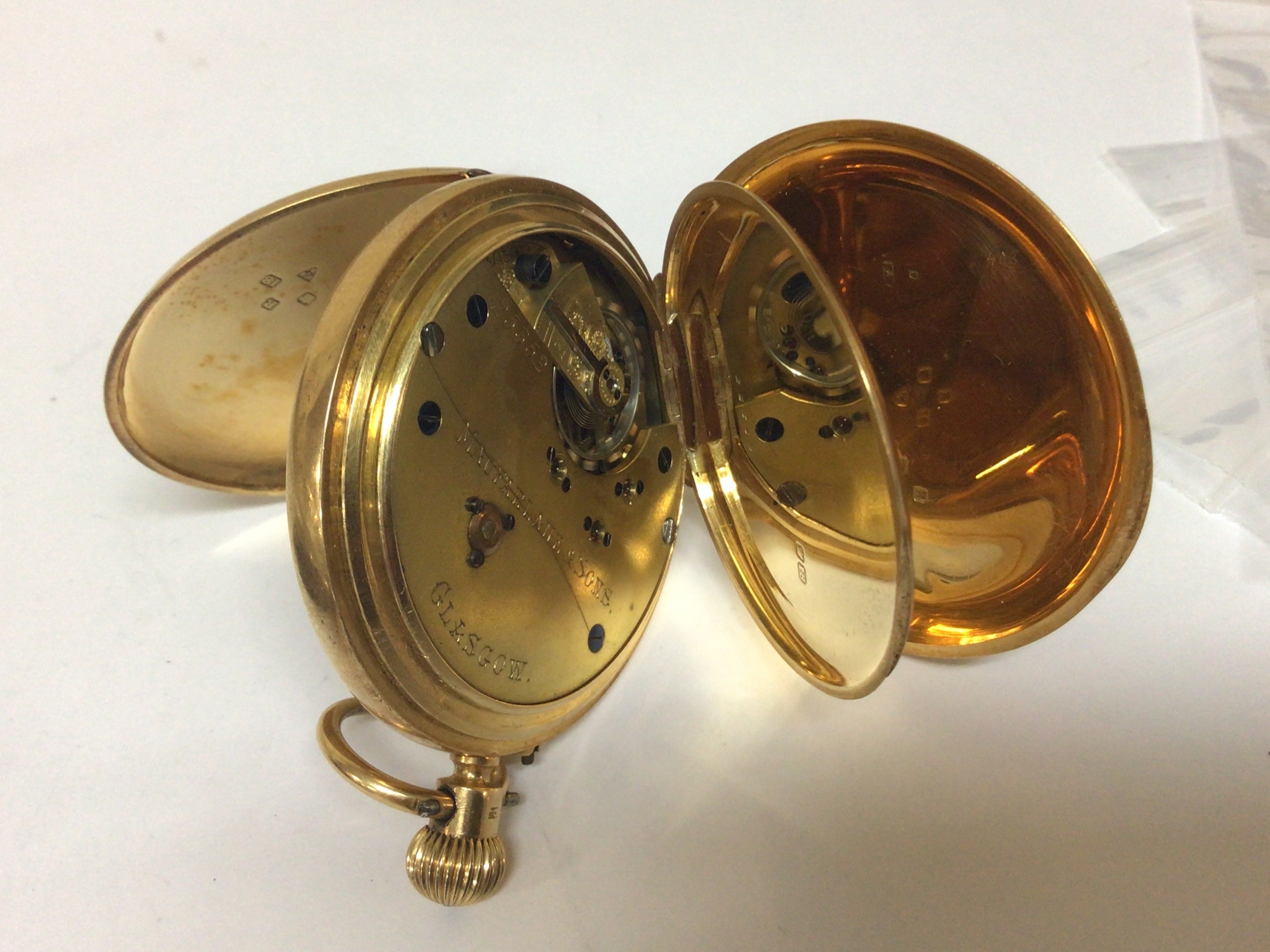  An 18carat gold full hunter pocket watch button wind seen working maker Macfarlane&Sons Glasgow. Serial number 25352. the case with engraved initials. Total weight 119g.