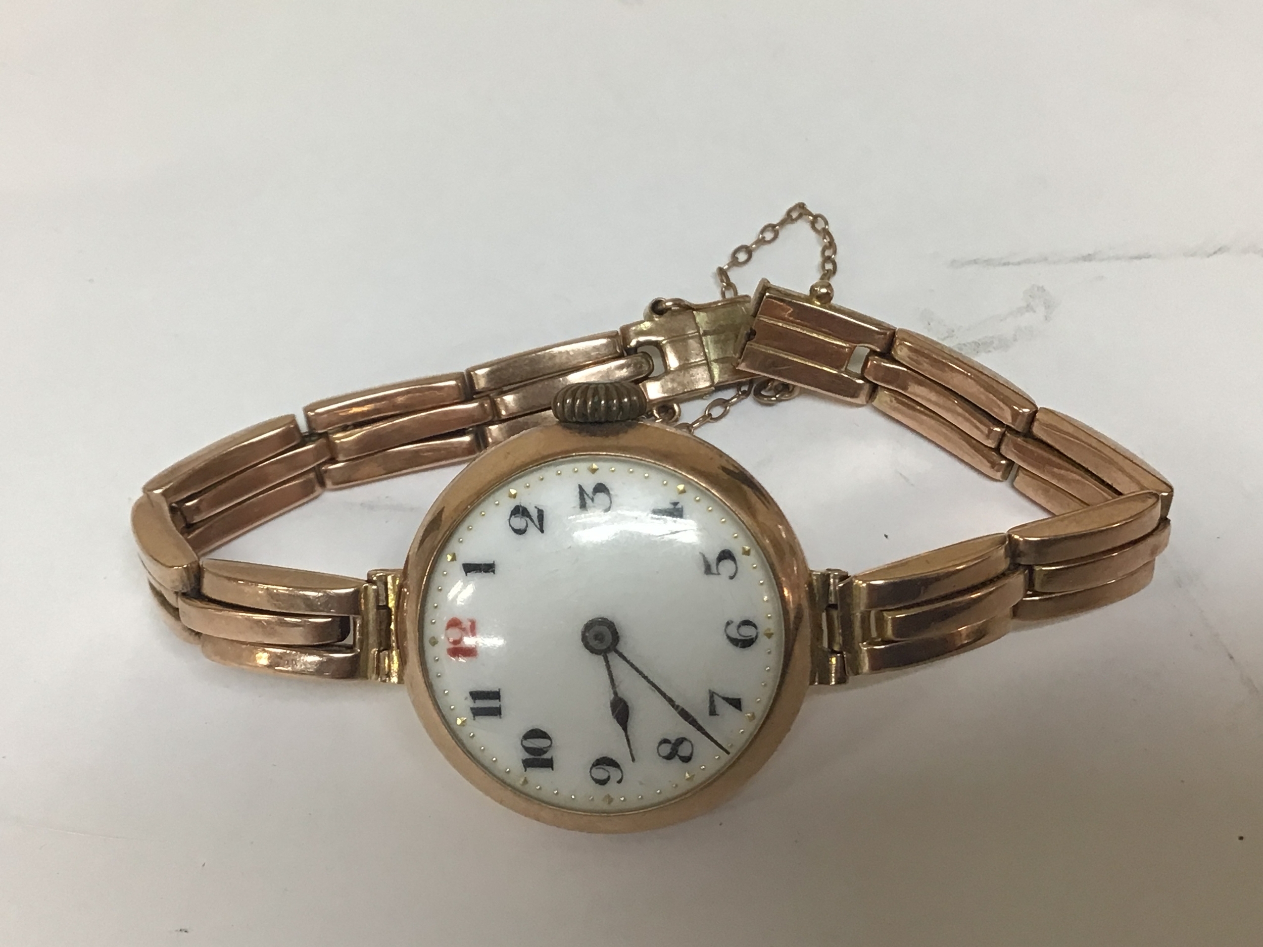  A 9carat gold ladies wrist watch with an expanding gold strap the back plate inscribed and dated 1921 total weight 24g 