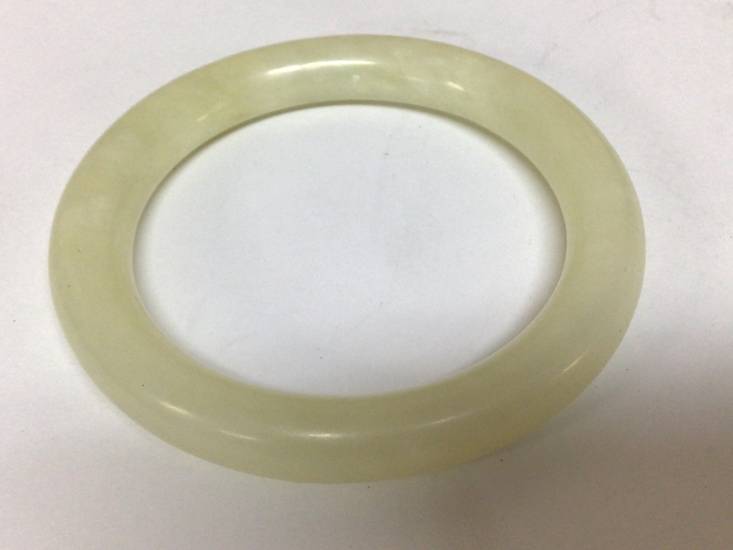 A Chinese jadeite bangle with full circular shape light coloured jade. Possibly very early 20th century. Approximately 82mm wide weight 51g. 