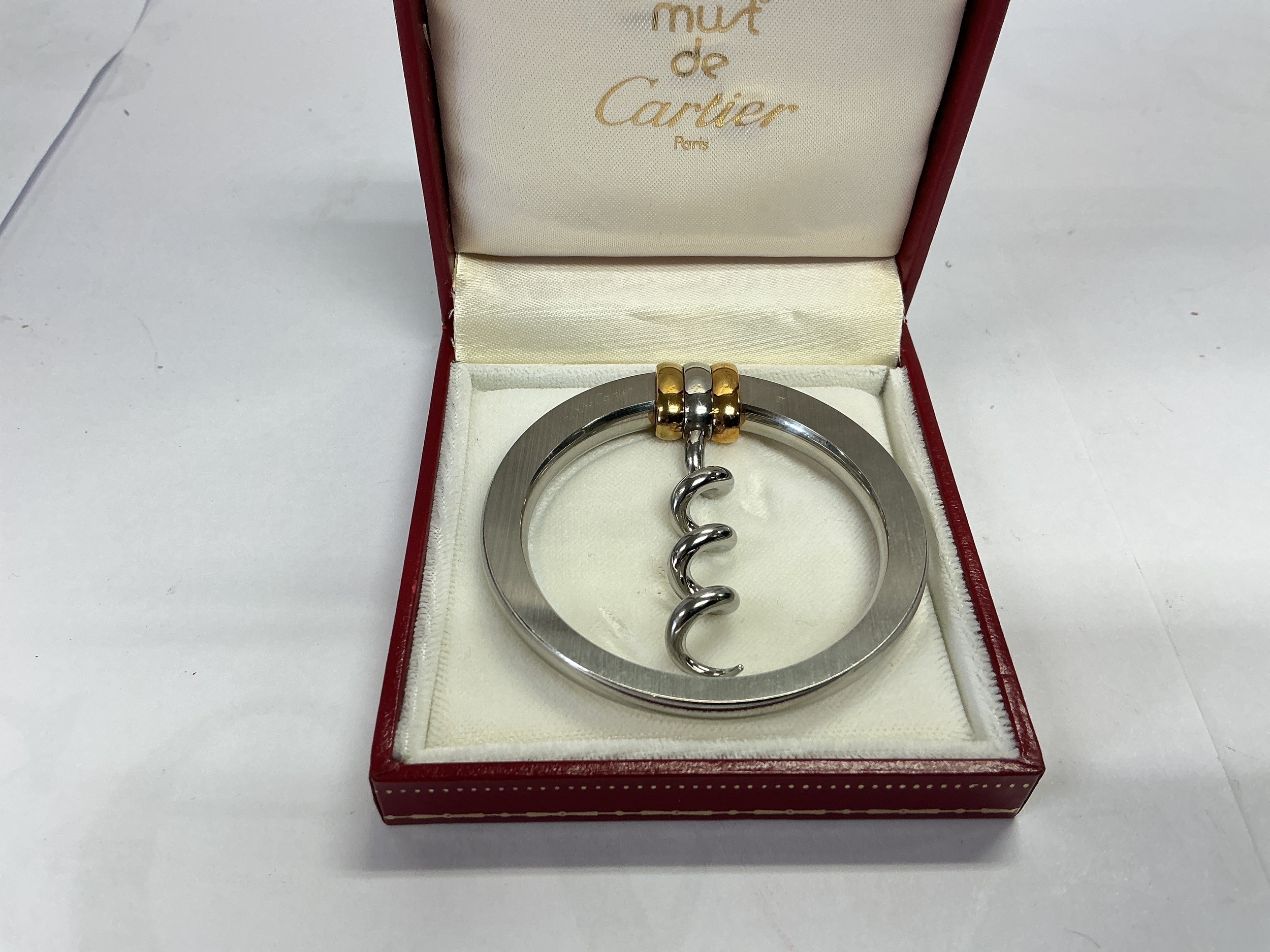 A boxed Cartier pendant in the form of a corkscrew, approx length 6cm.