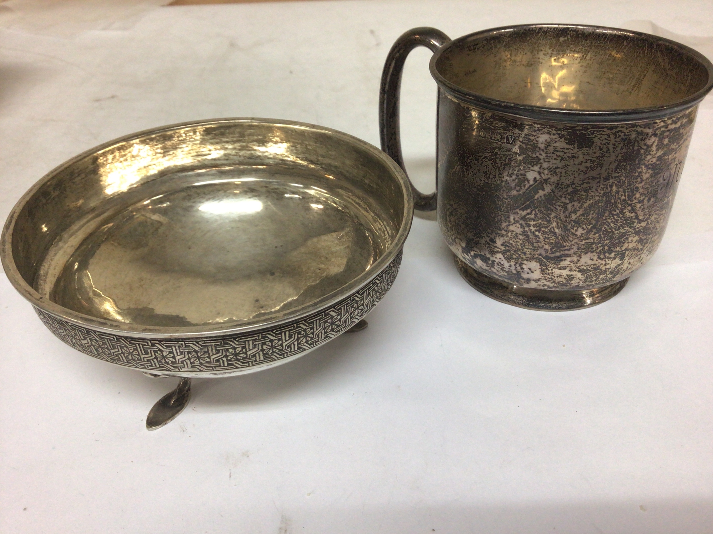  A Silver cup Birmingham hallmarks weight 79g  and an unmarked white metal dish unmarked (2) 