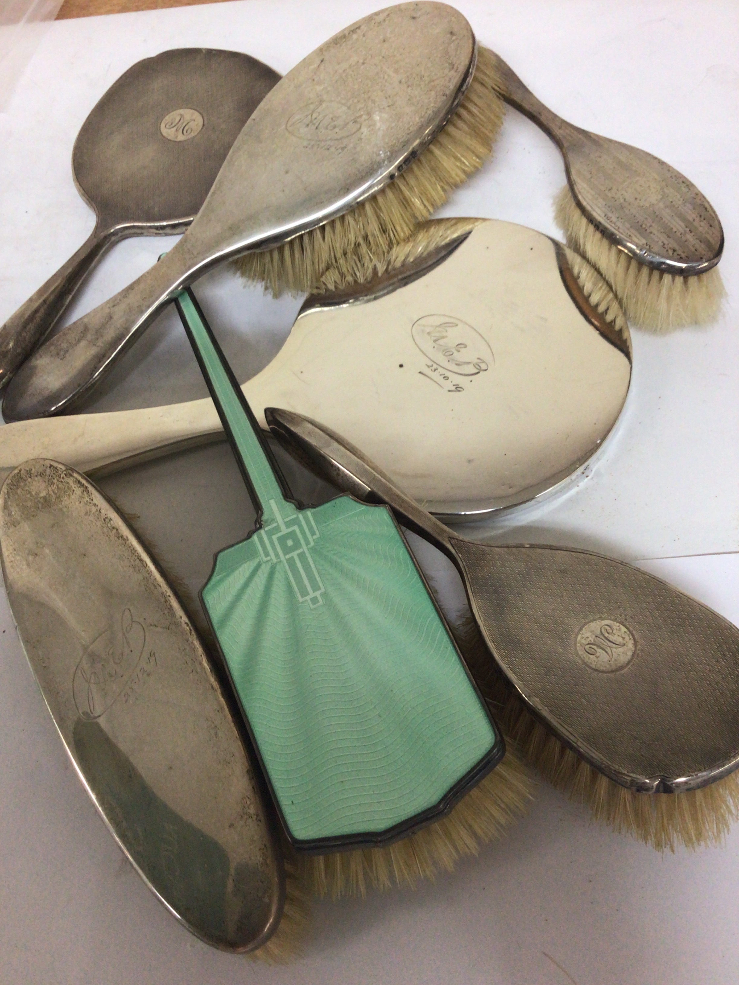 A Collection of silver backed dressing table brushes and mirrors 
