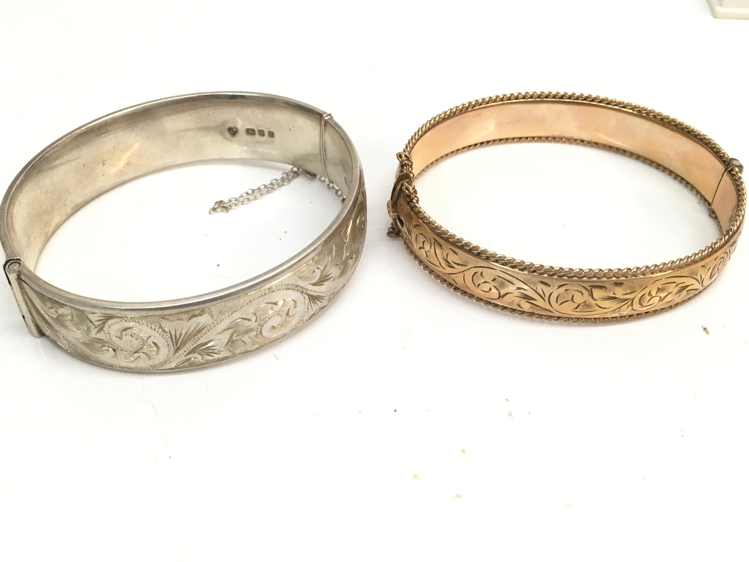 A 1/5th 9ct metal core bracelet (20g) and a silver hallmarked bangle (33g)