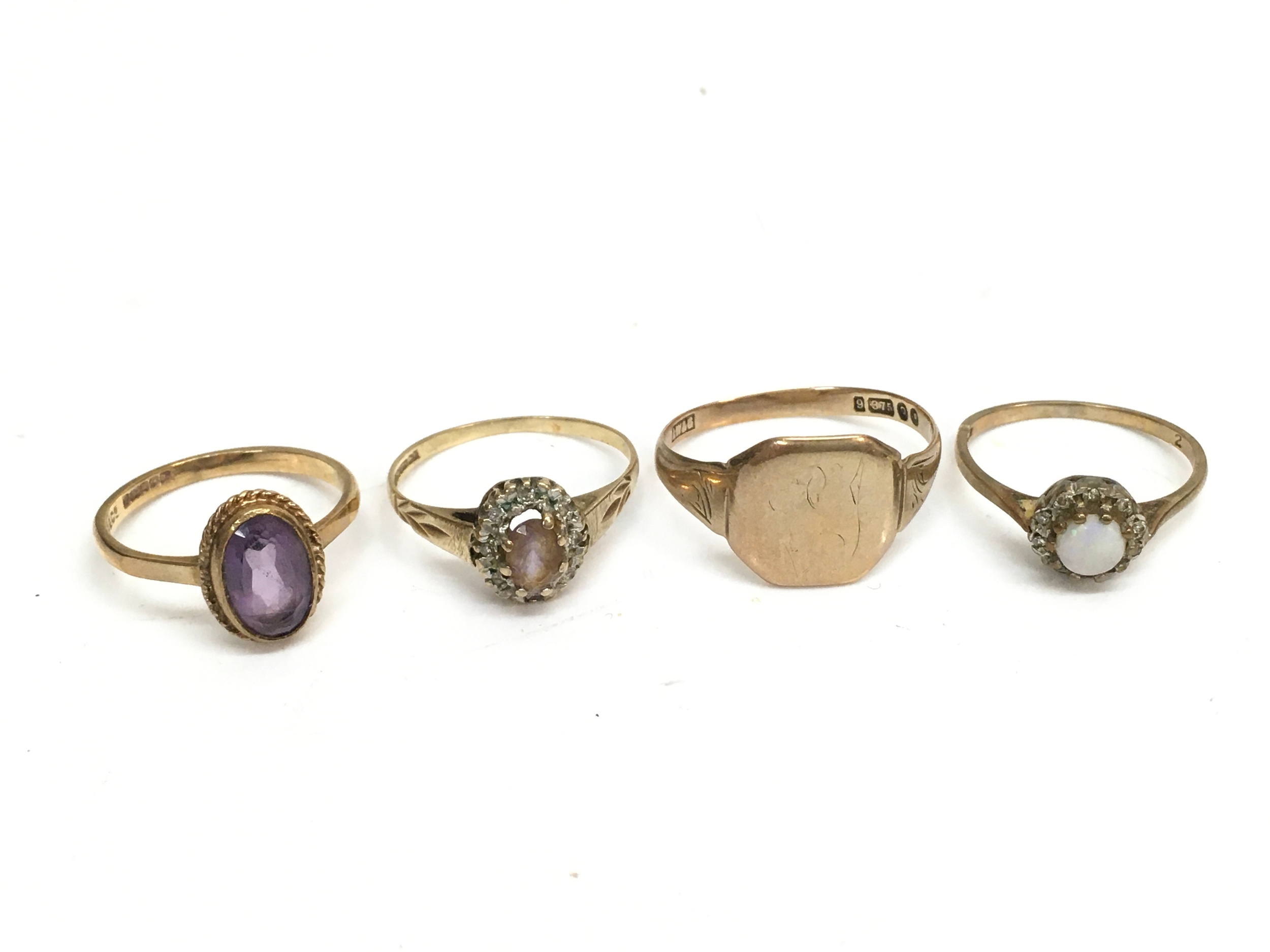 Four 9ct gold rings , three gem set and one signet ring. 7.8g total weight 