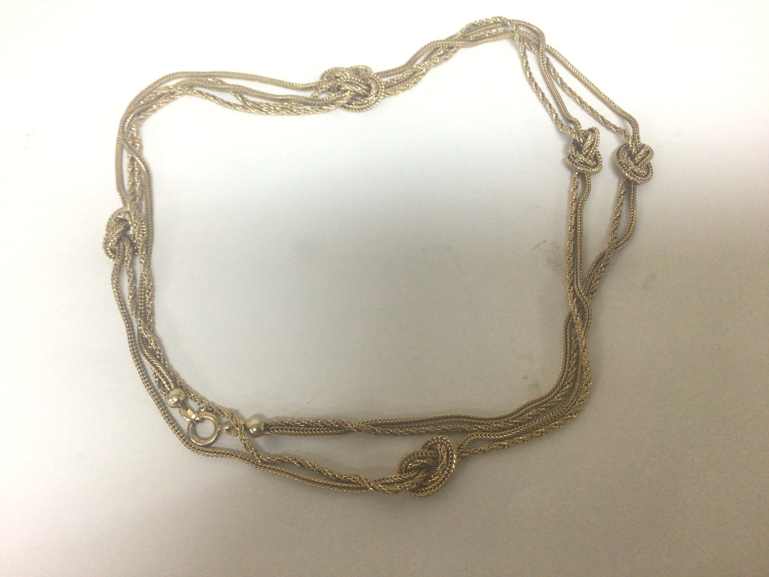  A 9carat gold double long guard chain with knotted ties and ball shaped links. Weight 20g 