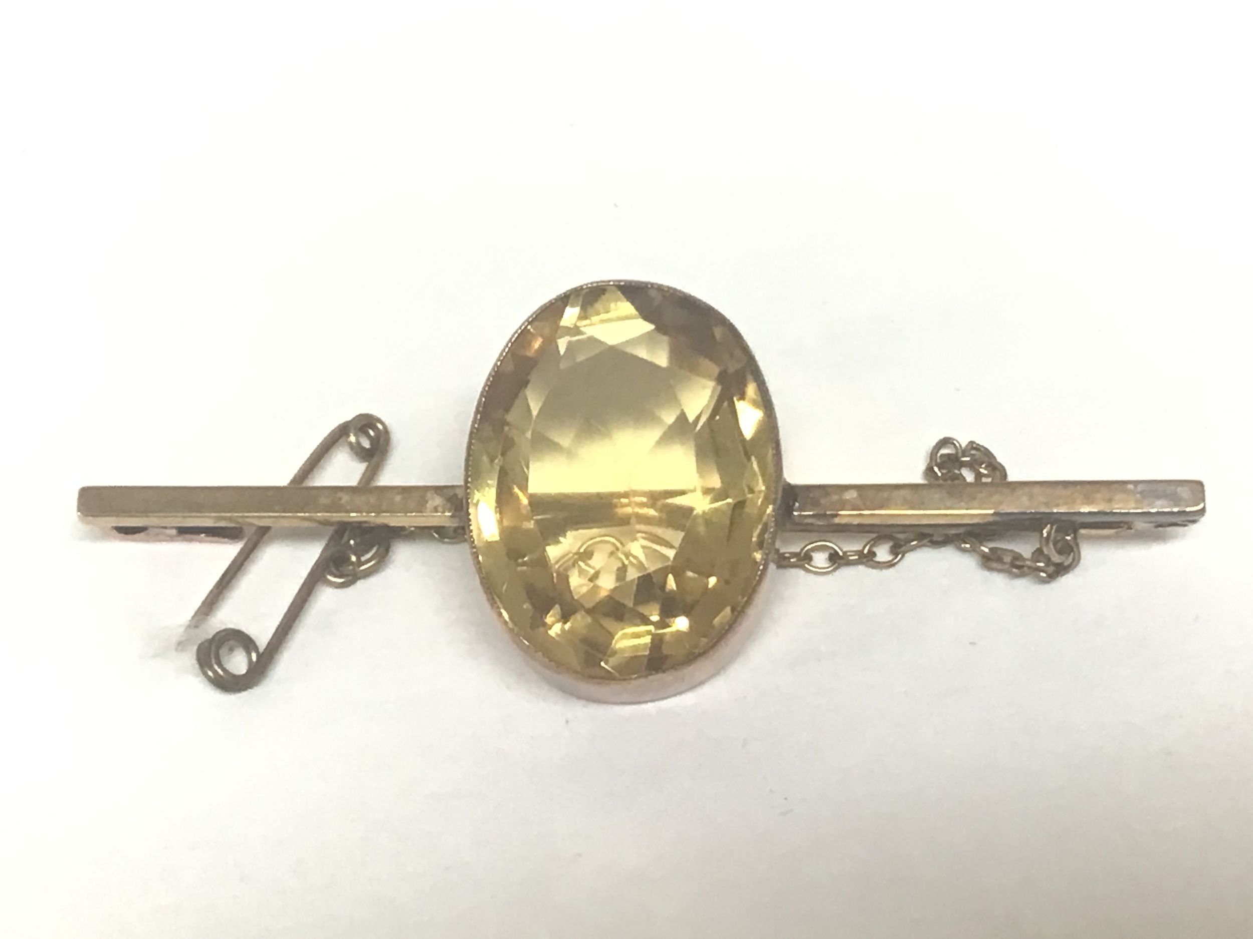  A 9carat gold bar brooch set with a large oval cut Citrine. Total weight 5.5g 