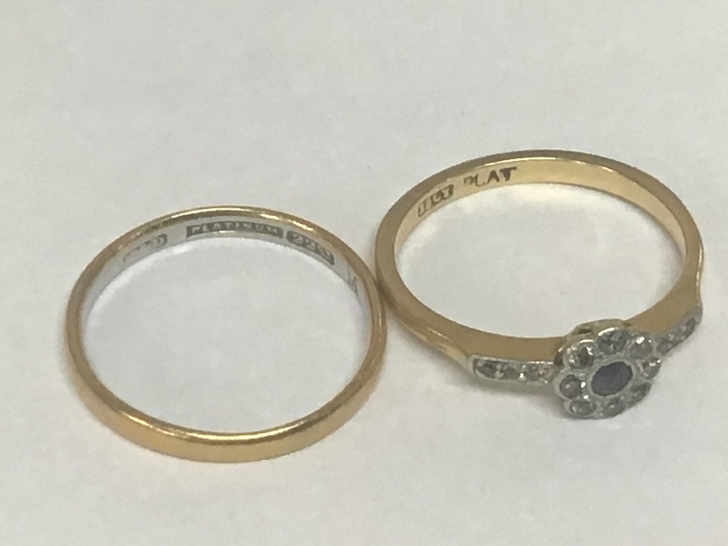  A 22carat gold and platinum wedding ring weight 2g and an 18carat gold ring set with a small sapphire and diamonds weight 2.4g (2) 