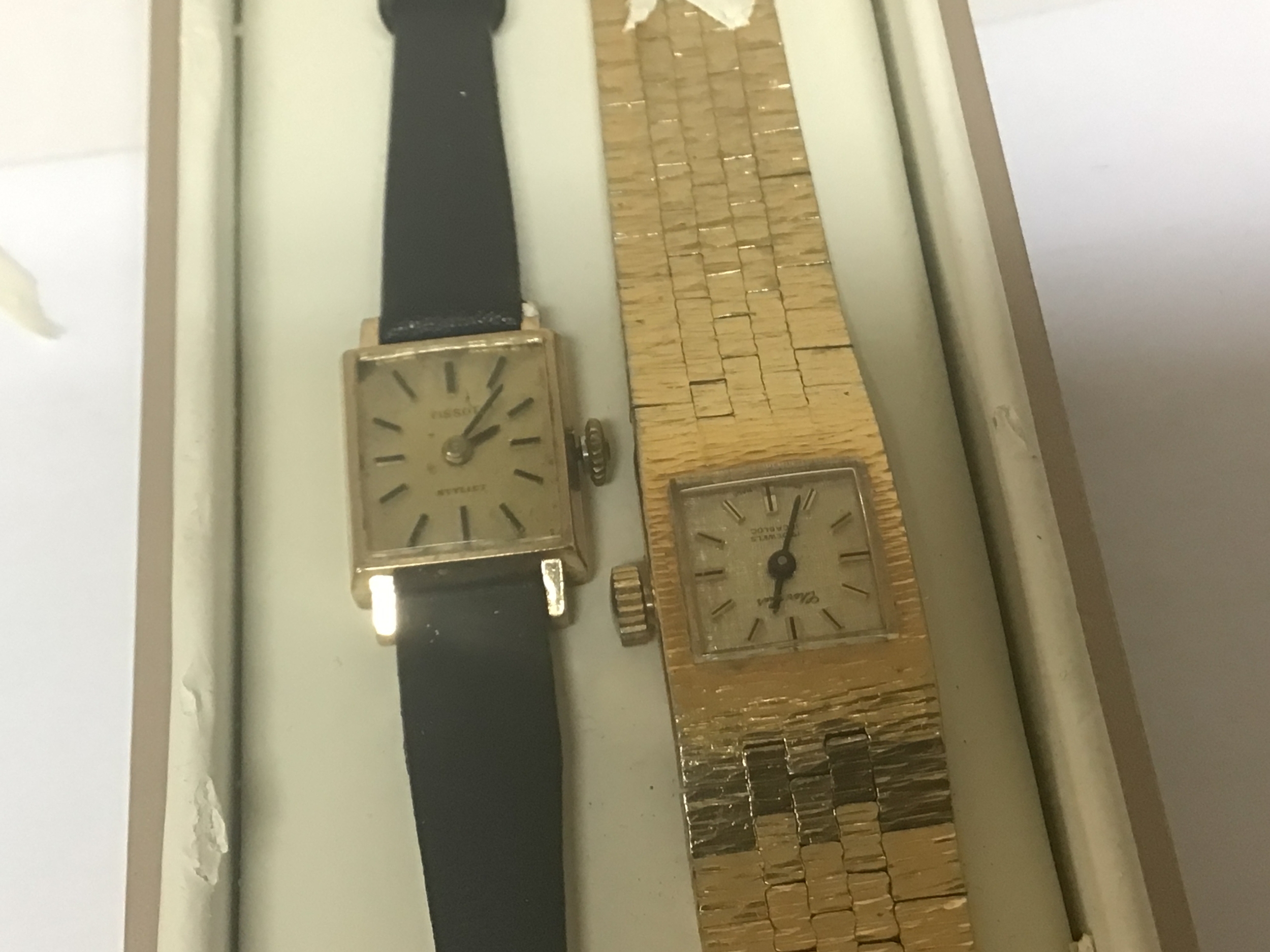  A 9ct gold cased ladies Tissot watch with a leather strap and one other gold plated watch (2) 
