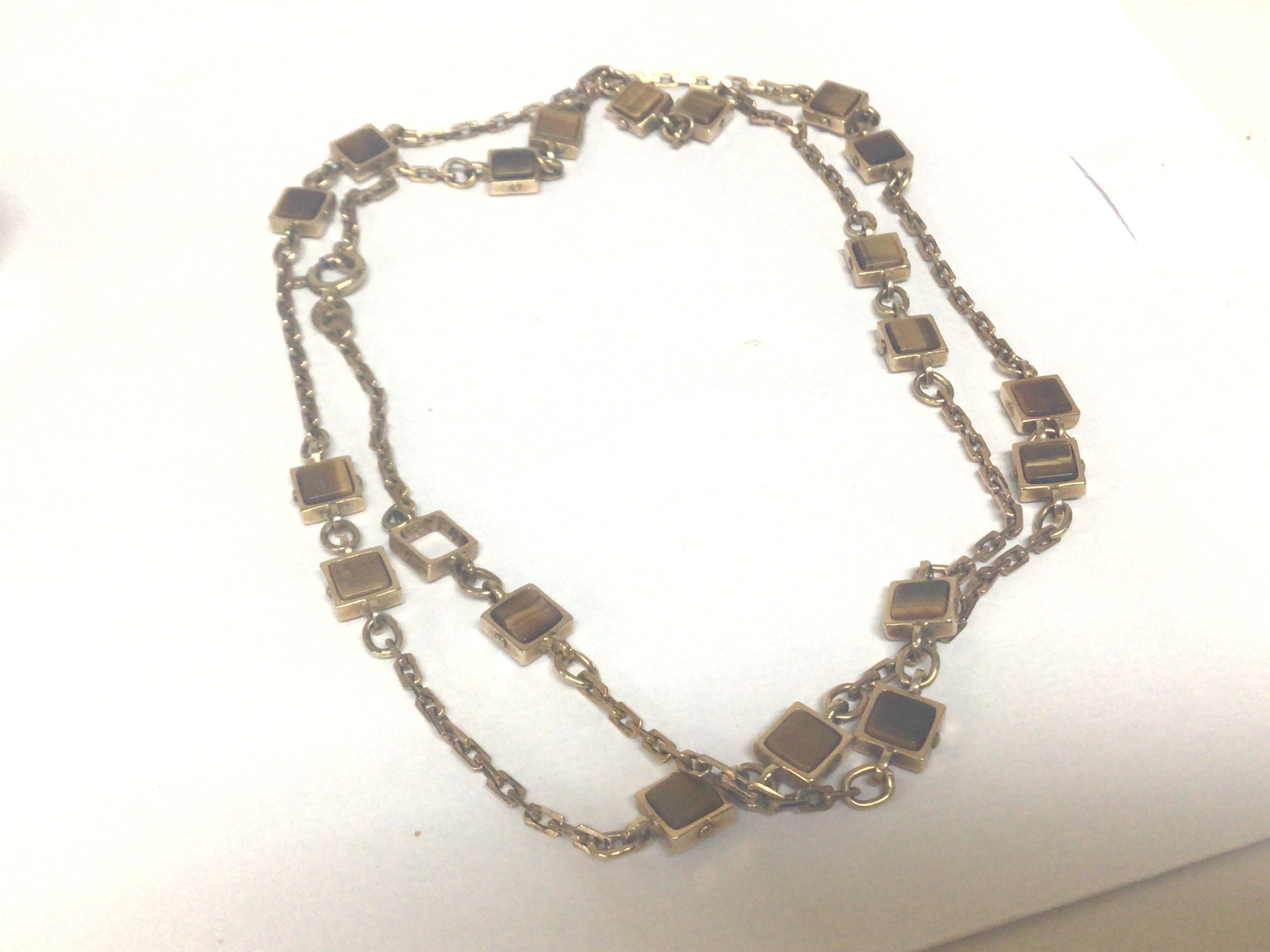  A 9carat gold necklace set with square links set with tigers eye polished stones total weight 15.5g 