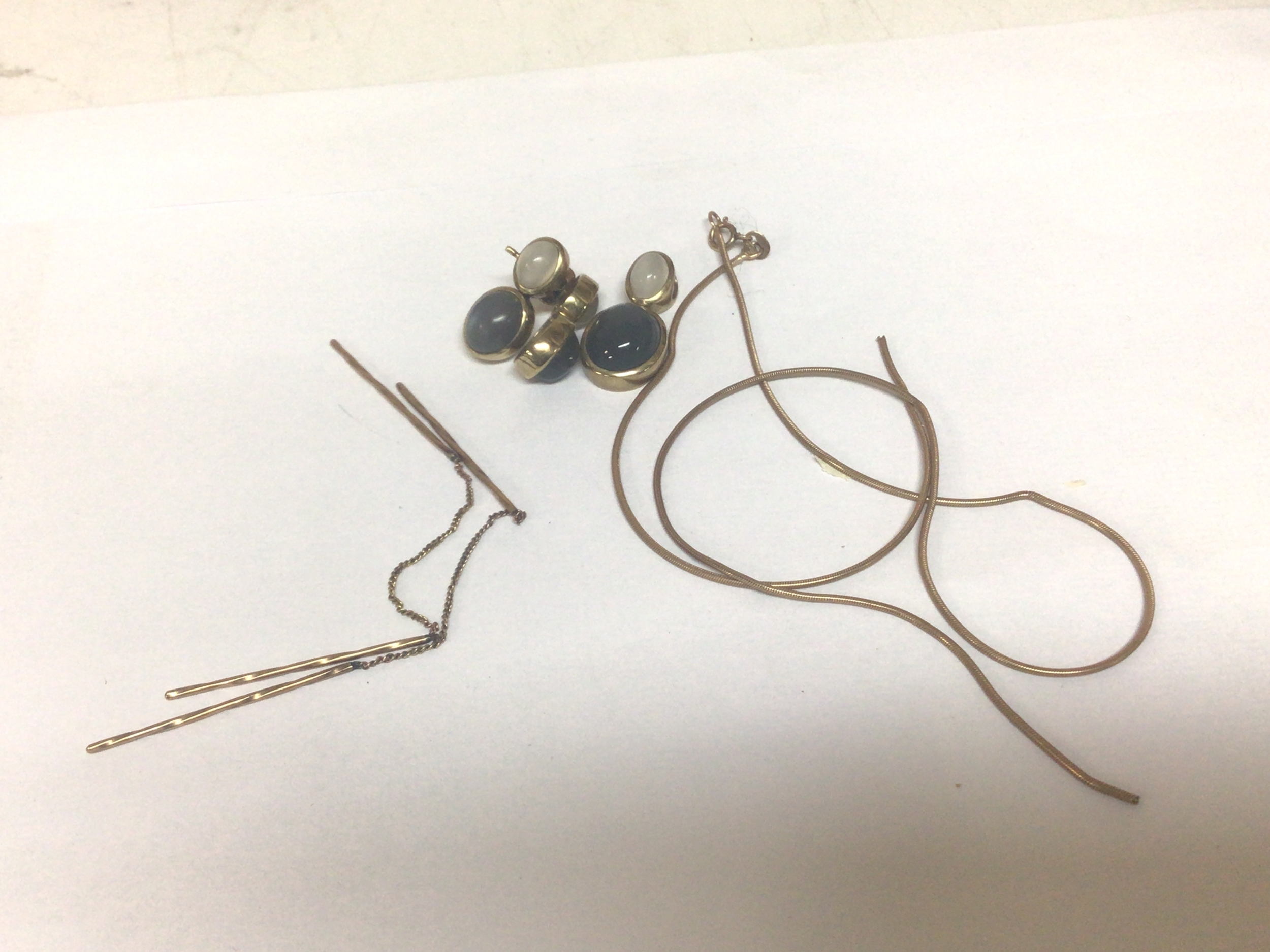 A 9carat gold necklace (broken) and yellow metal earrings set with cabochons and one other pair of earrings. 