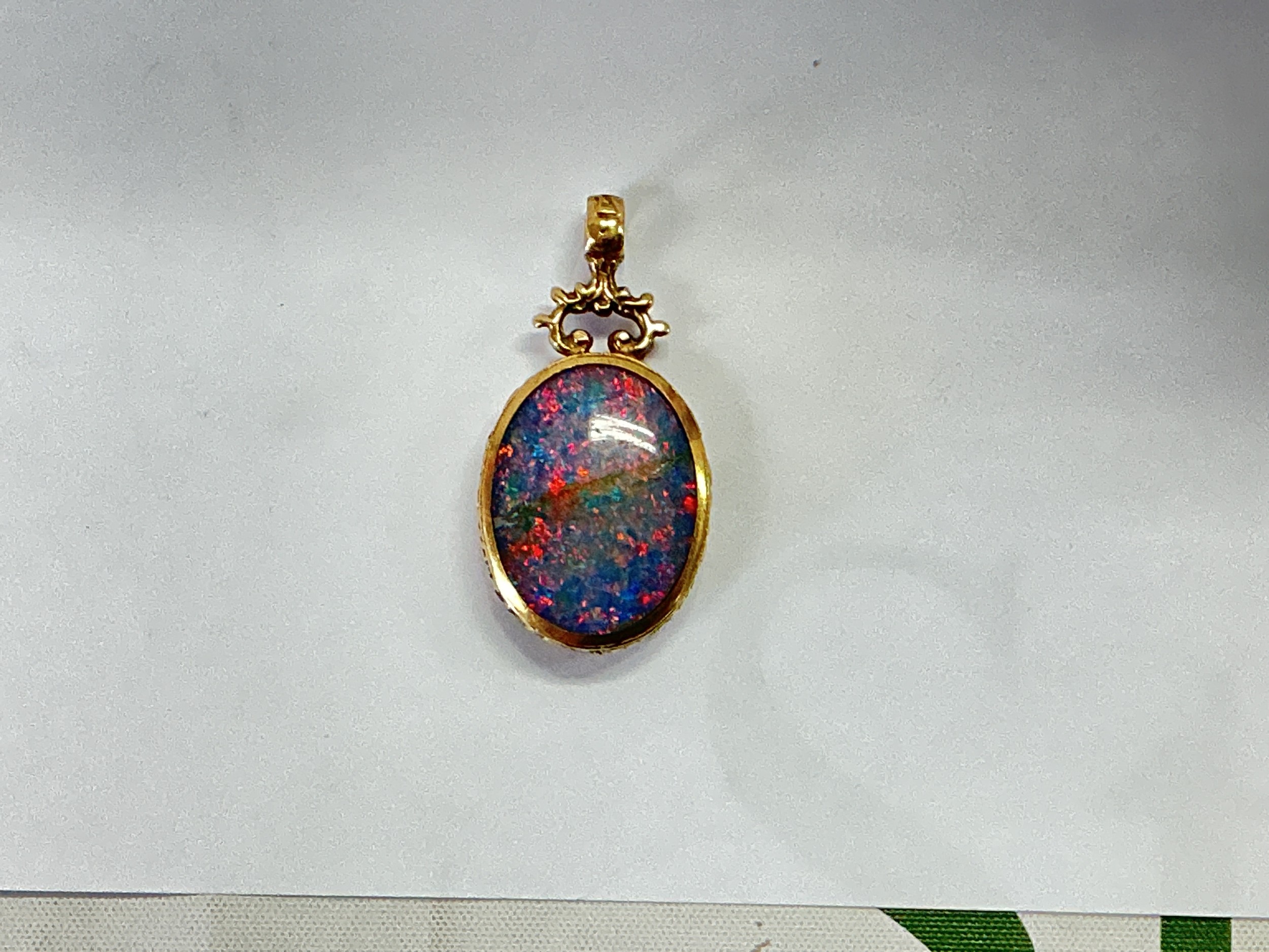 A 9ct gold opal doublet pendant, approx 14.7g.