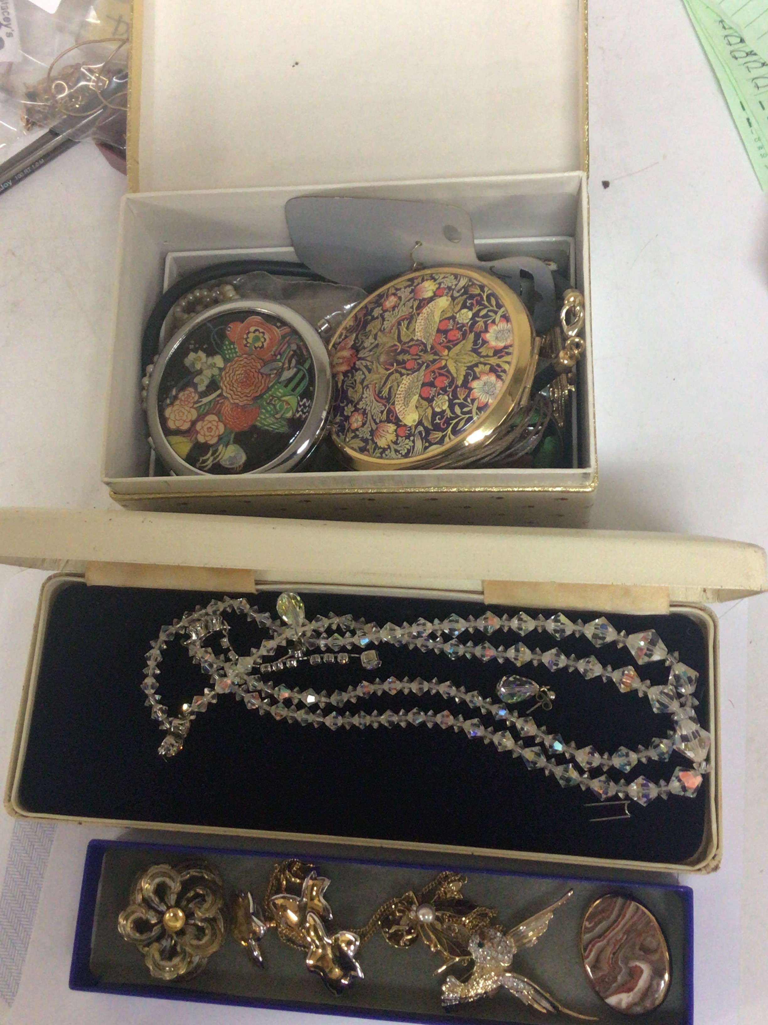 A Collection of costume jewellery brooches compacts and including some silver jewellery.