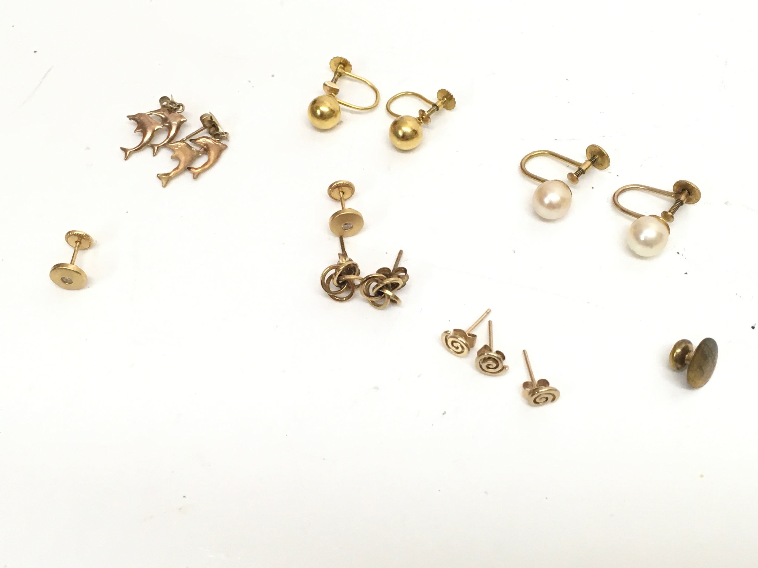 A Collection of 9ct gold earrings including pearl, dolphin designs. 6g total weight 