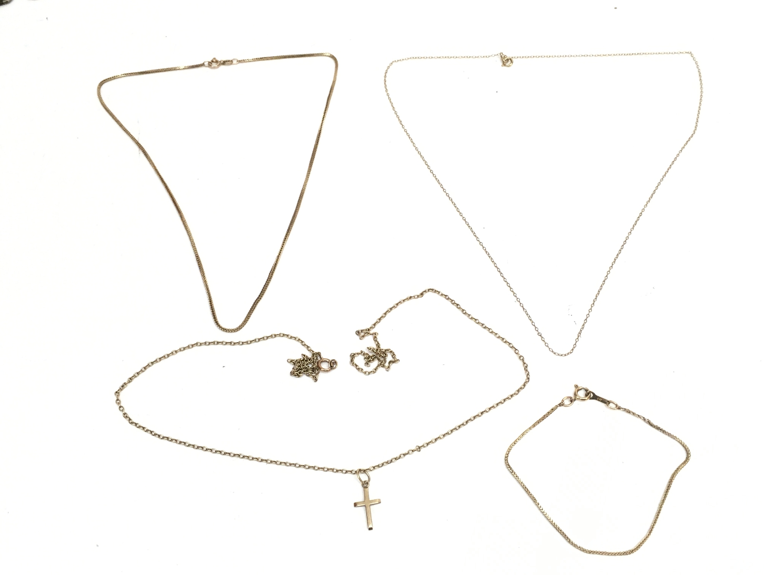 Three 9ct gold necklaces one with a cross pendant and a 9ct gold bracelet. 8.8g total weight