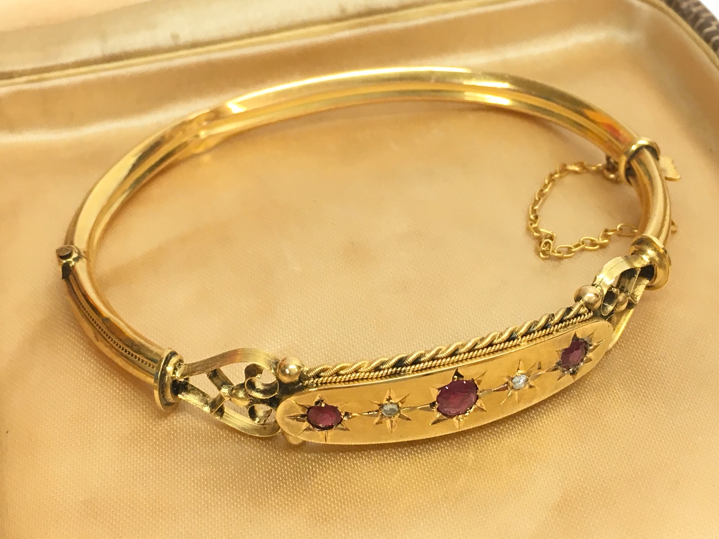 A 9ct gold ruby and rose cut diamond bangle , 8.6g total weight. 7cm wide 