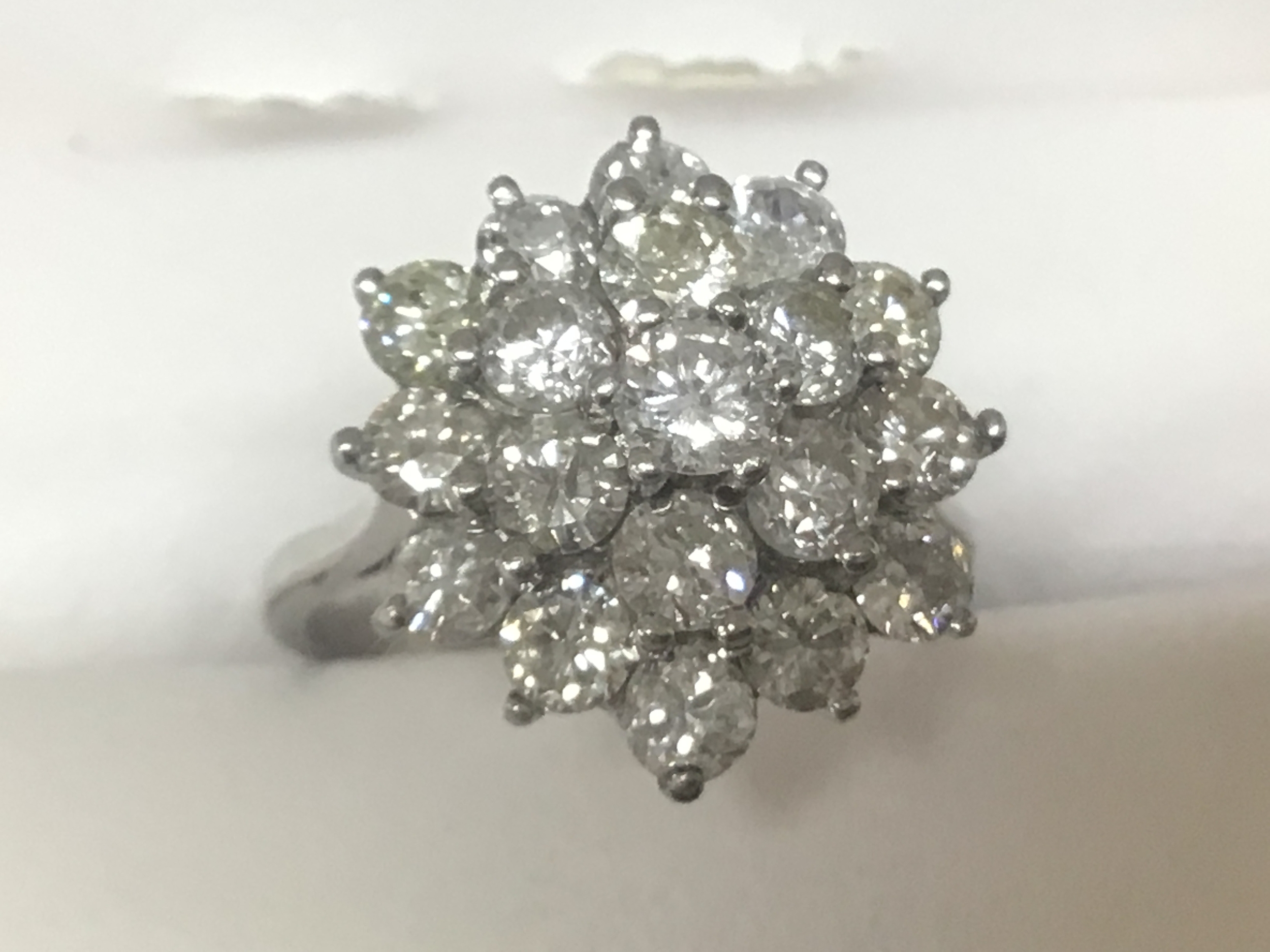  A ladies White gold or platinum ring (unmarked) set with a cluster of diamonds very good colour and clarity in a floral pattern spread weigh in excess of 2carat diamond. With a total of 19 brilliant cut stones the shank with an internal engraved number 149 ring size O-P total weight 5g 
