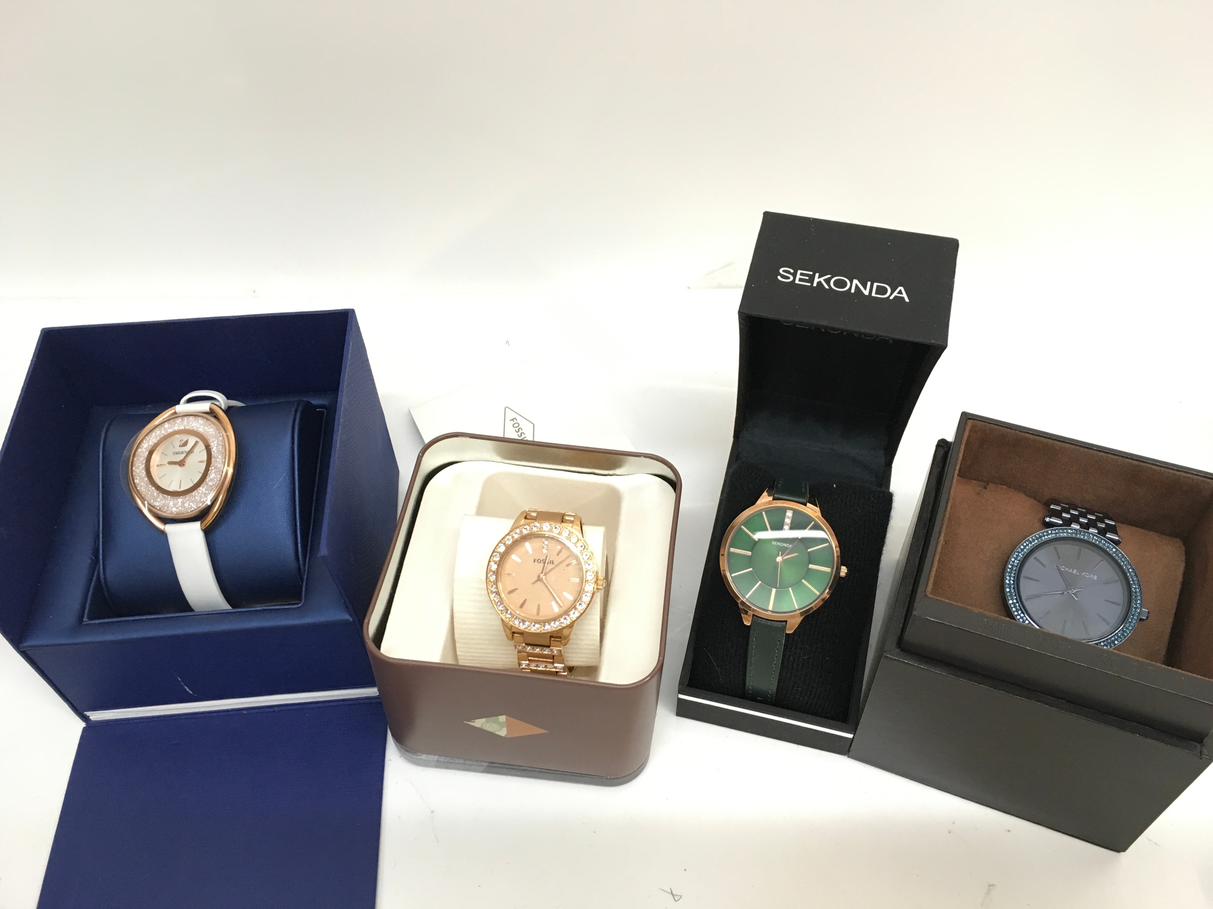 Four watches Swarovski, Fossil, Sekonda, Micheal Kors
