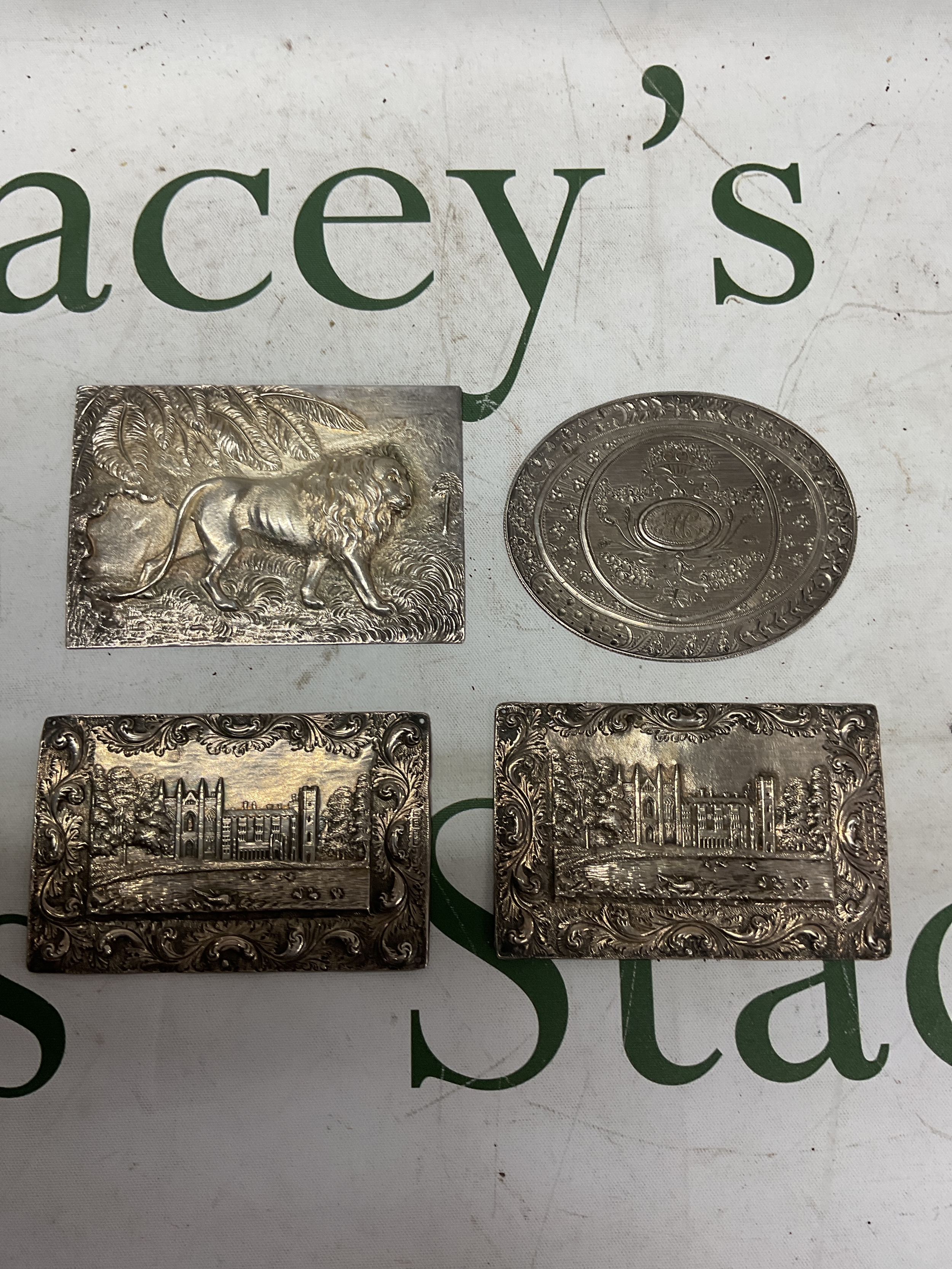 Two 19th c HM silver castle top panels Birmingham 1835 makers mark T&P, along with two white metal examples of an embossed lion and an oval floral engraved example.