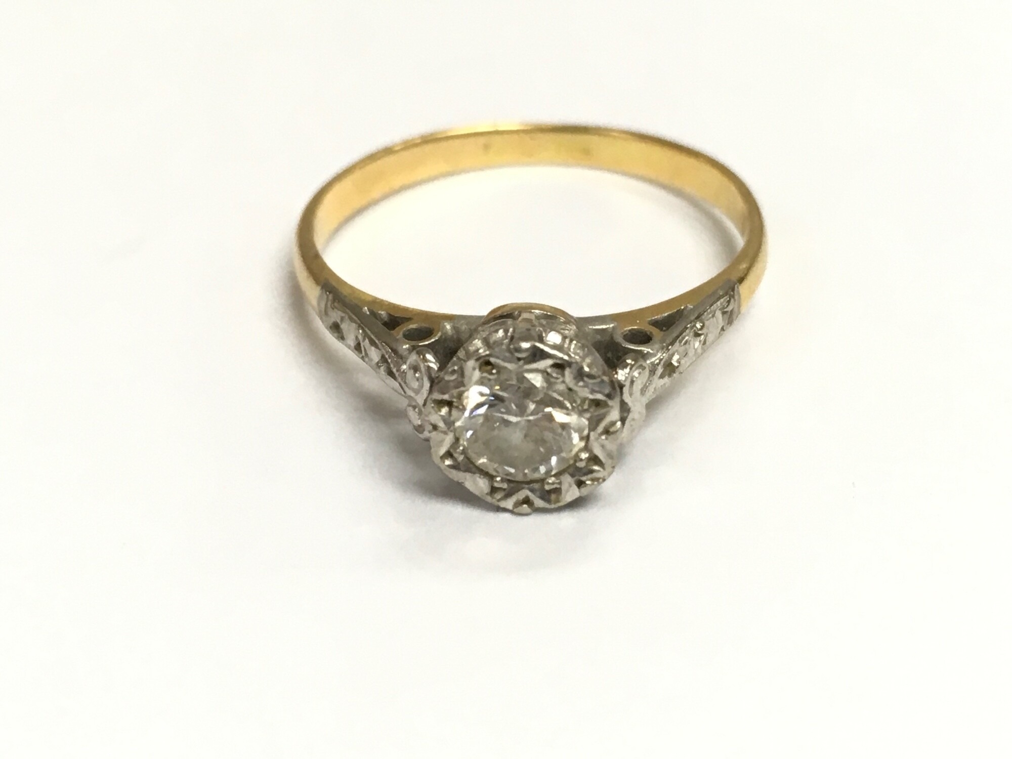 withdrawn  - An unmarked gold and platinum solitaire ring. Size L 1/2 and 2.36g