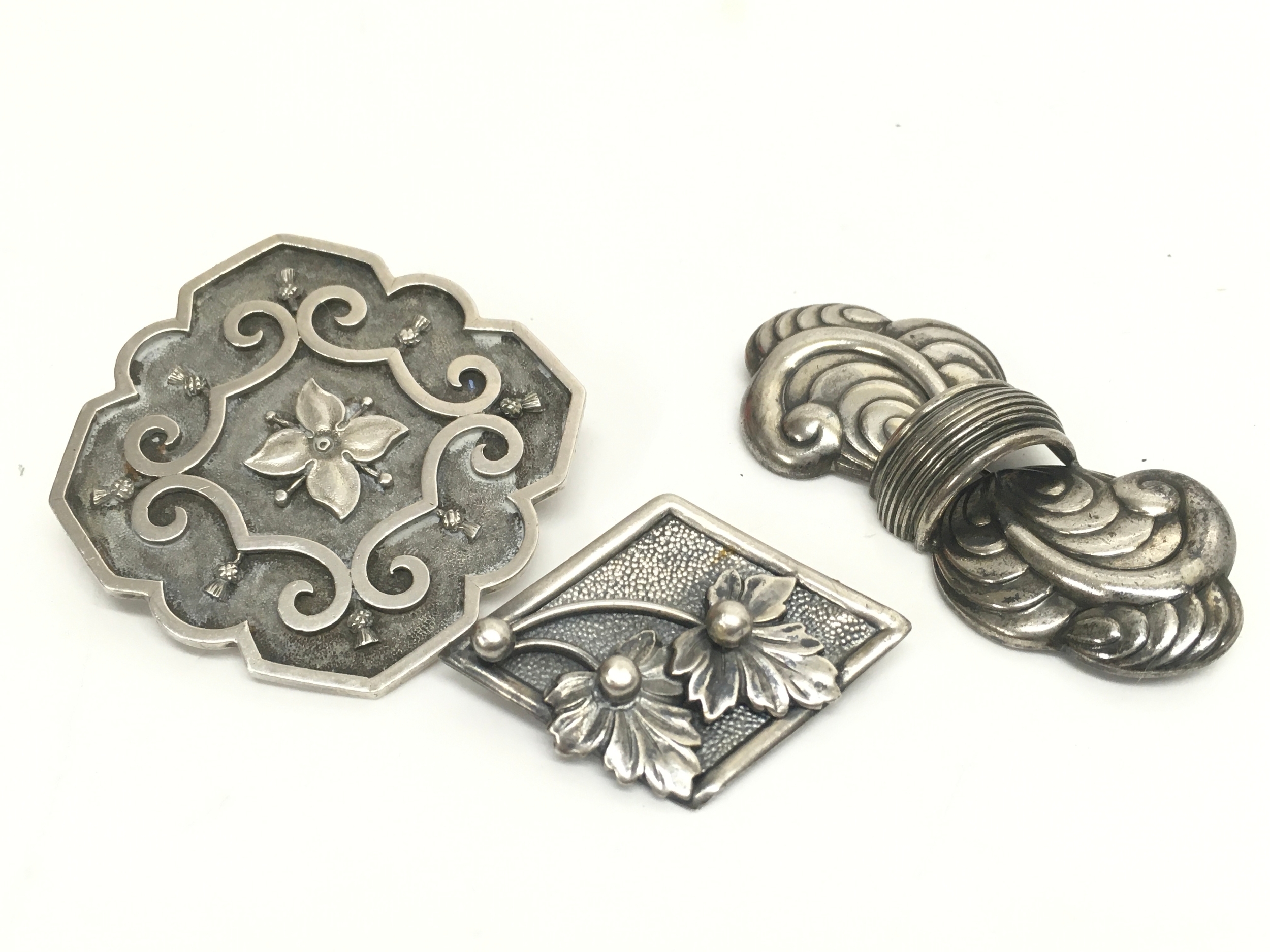 Three silver brooches- Wheatley Carlisle, Stersily Candida and one unmarked.