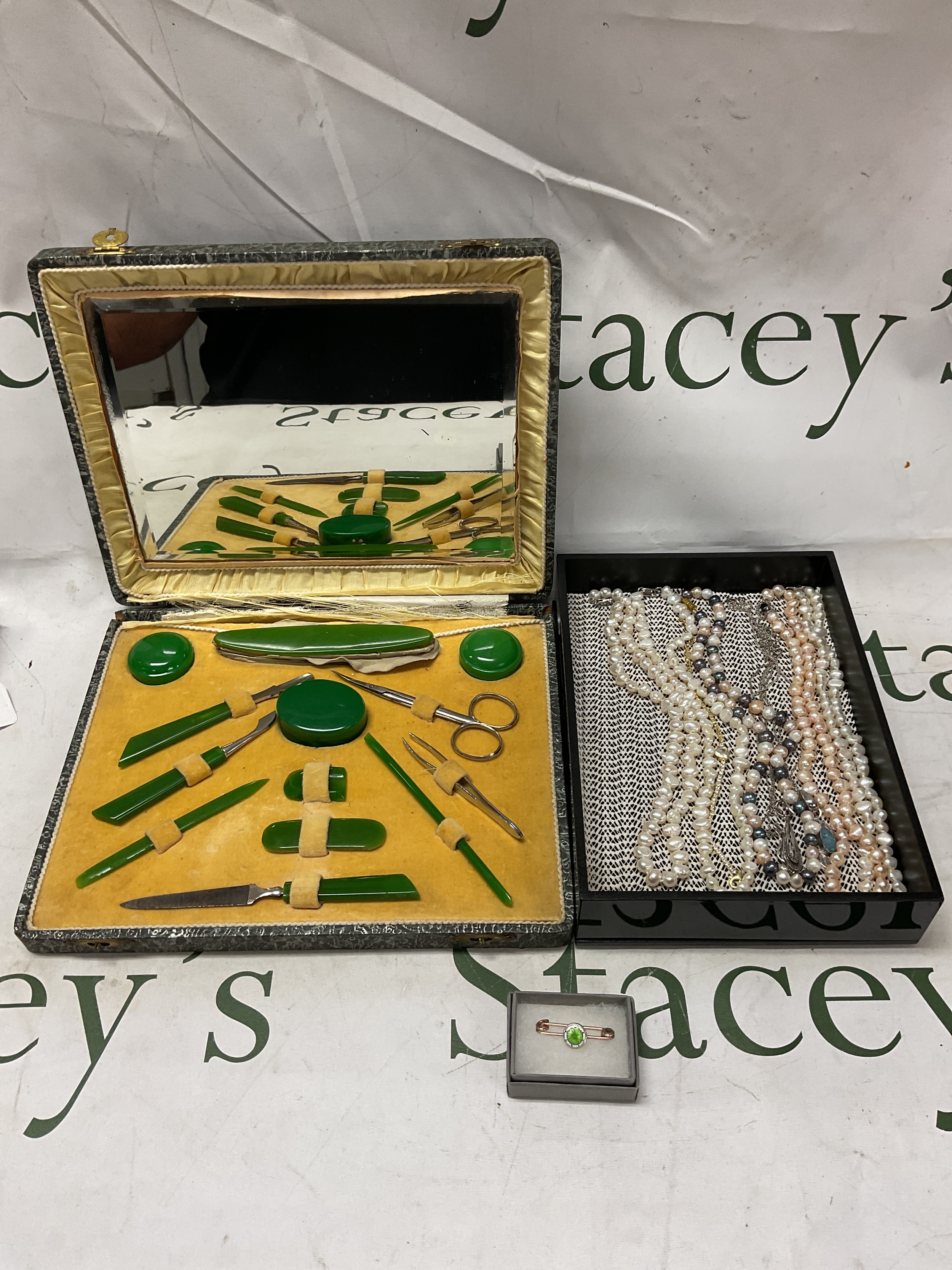 Collection of pearl necklaces, three silver necklaces, an enamel pin and a vintage manicure set.