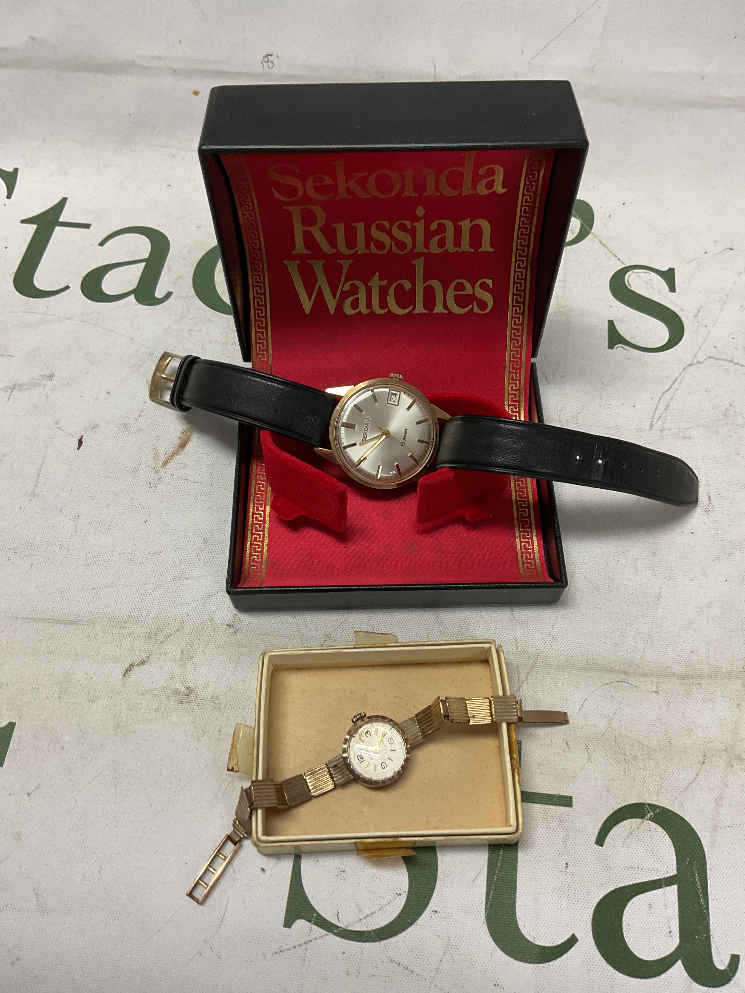 9 ct gents 18 jewel sekonda and a 9ct ladies watch on rolled gold bracelet.