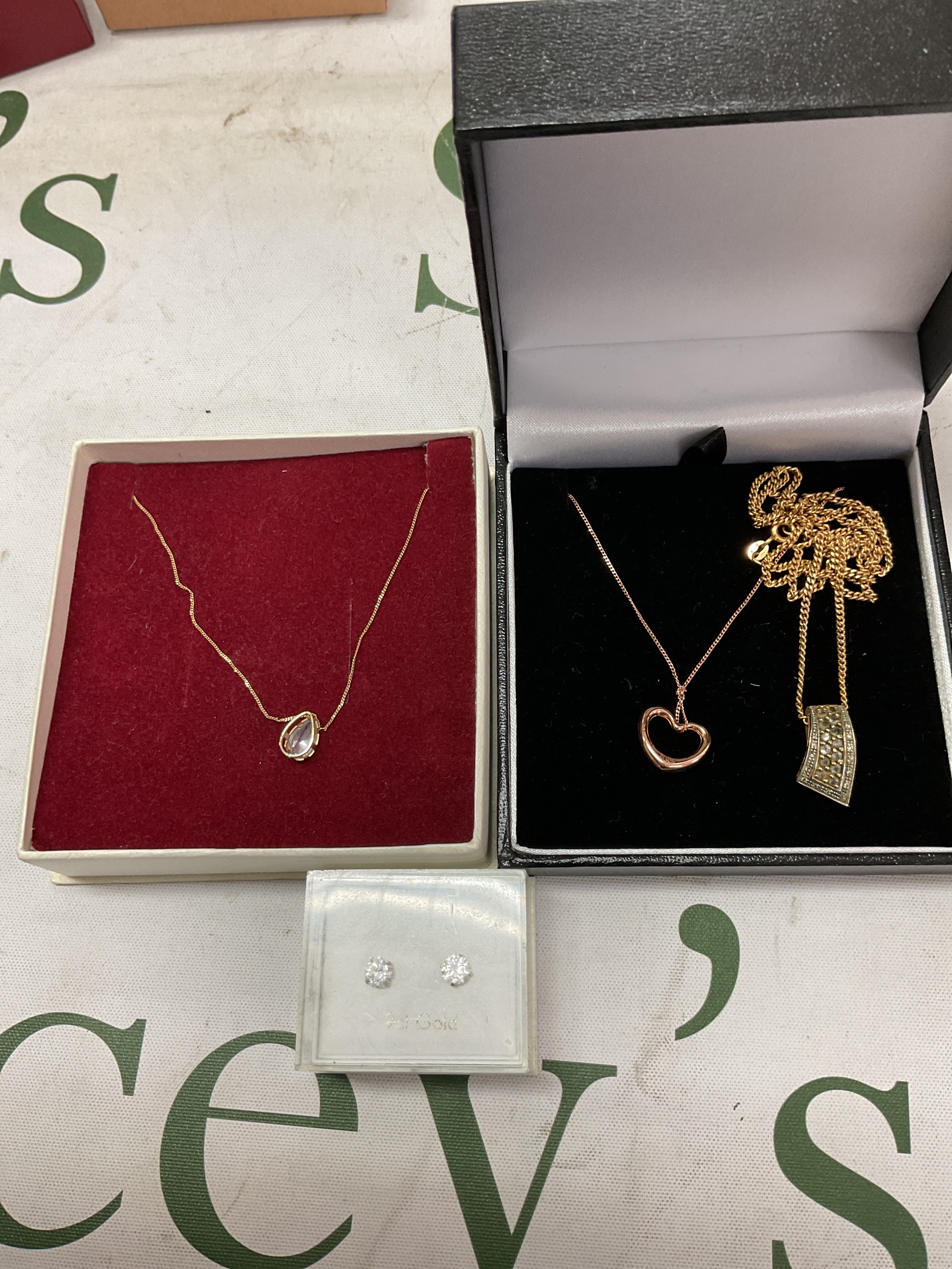 Three 9 ct necklaces and pendants and gold CZ earrings.