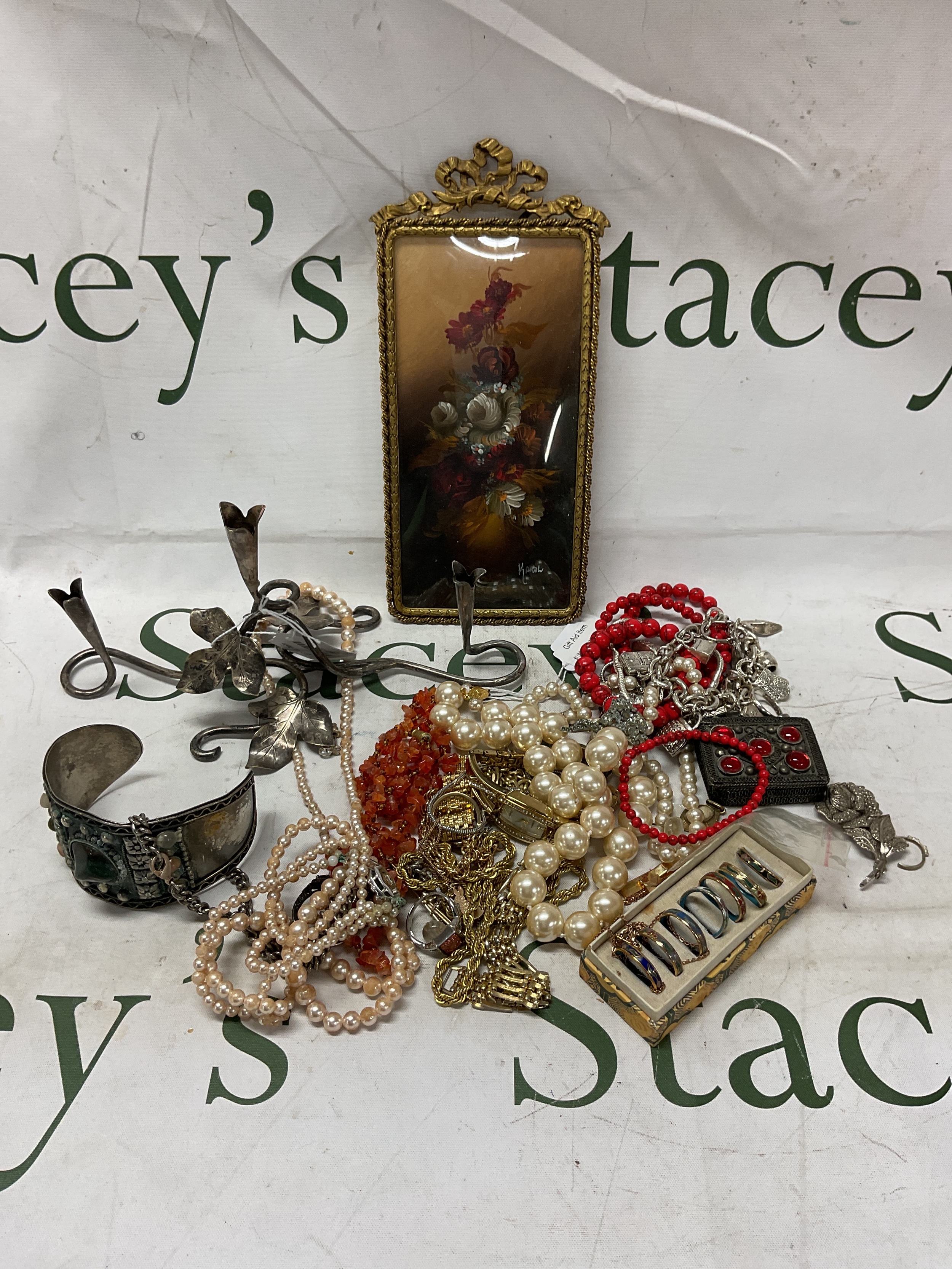 Silver plate floral taper holder. A signed framed oil of flowers, and dress jewellery .