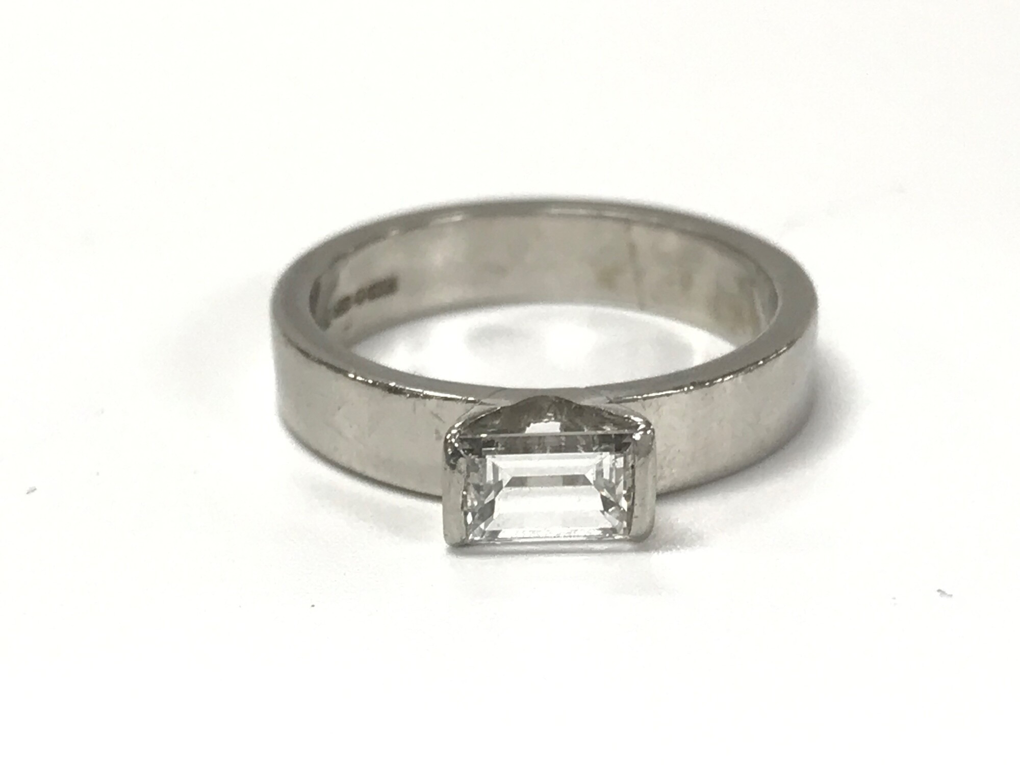 A platinum emerald cut diamond solitaire ring. 0.61ct diamond size L and 6.51g. VVS2/ Colour F,