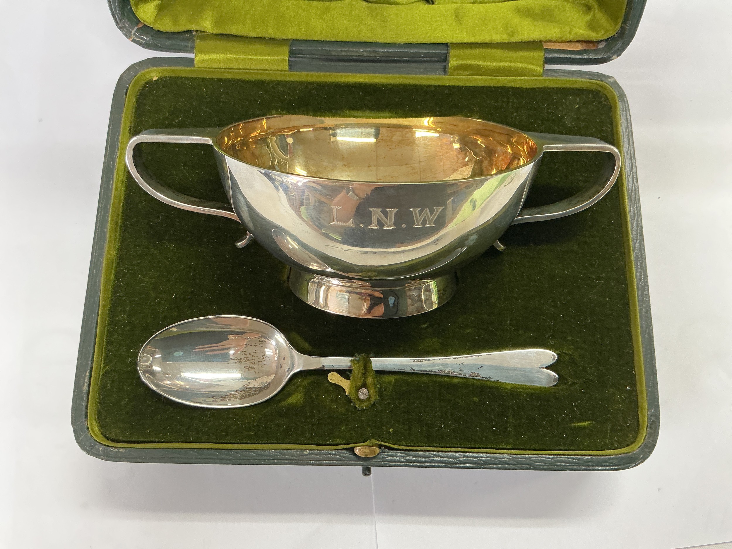 A cased christening bowl and spoon, different hallmarks, approx total weight 211g.