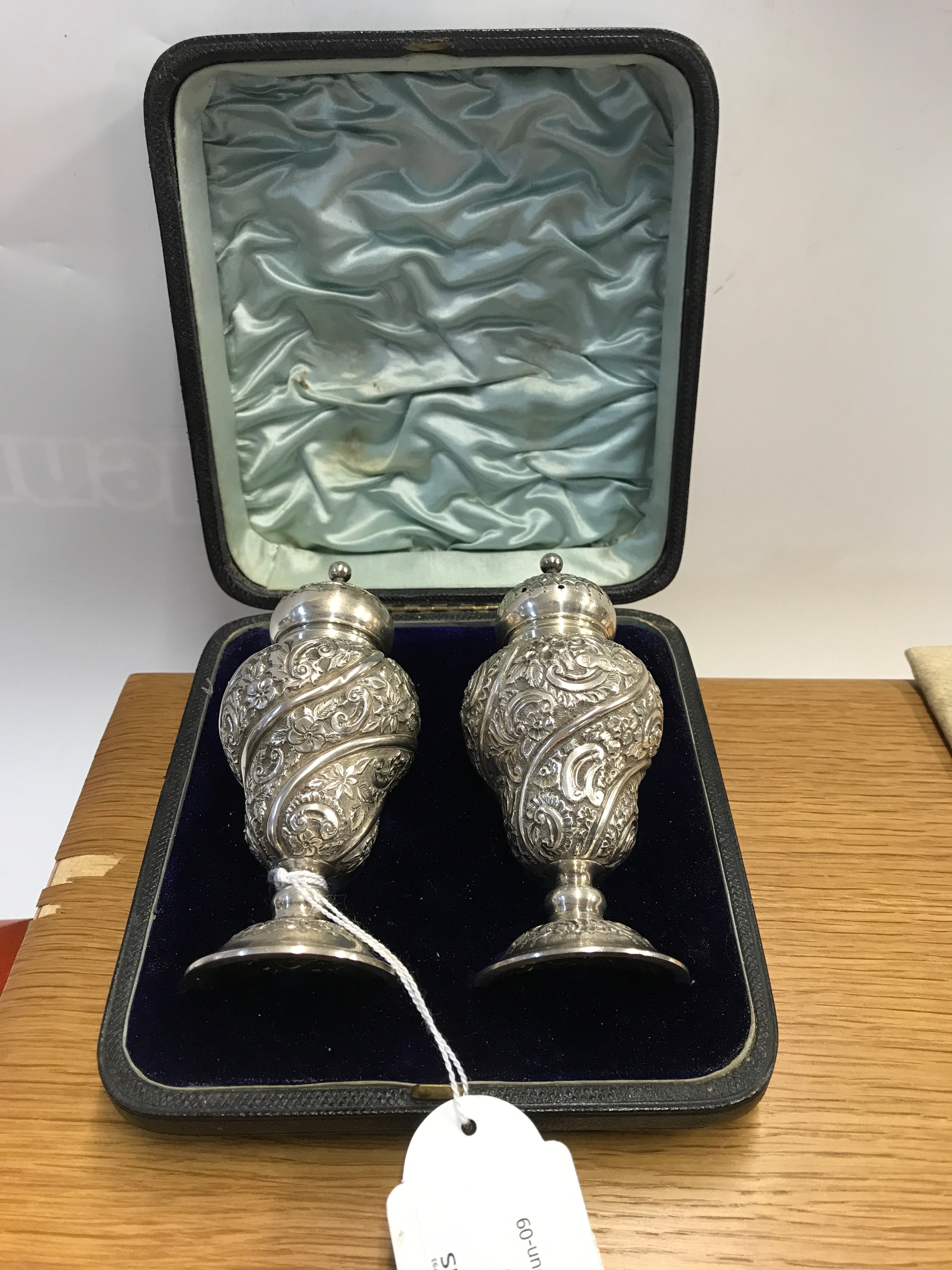A pair of elaborate decorative hallmarked silver Victorian pepperetts by William Hutton 105g