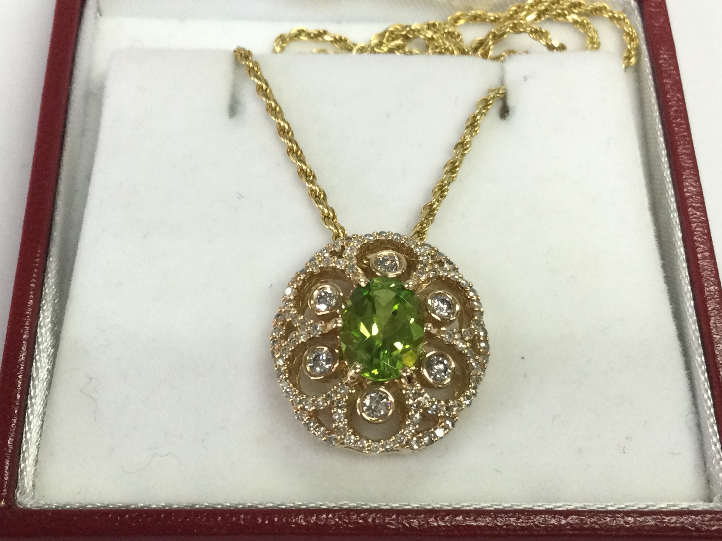 Vintage styled 14ct gold oval pendant set with peridot and diamonds. Peridot 1.80ct and diamonds 1ct.