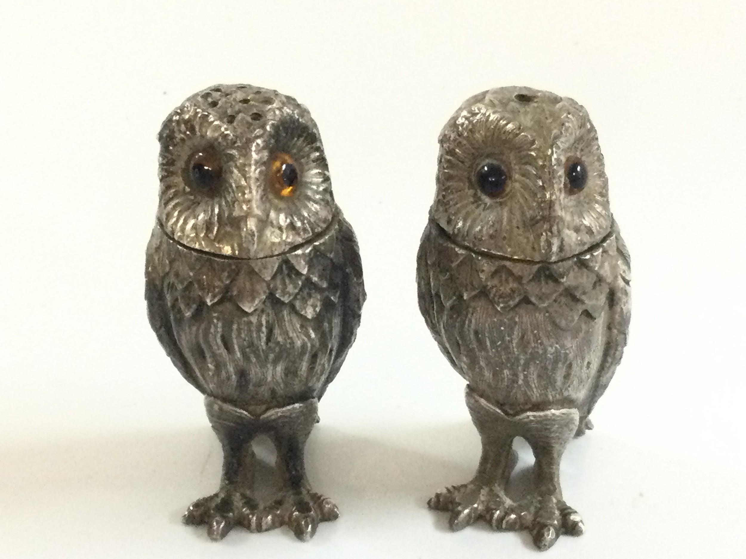 A pair of Tiffany and Co silver sterling owl salt and pepper shakers. 140g total weight. 6cm tall