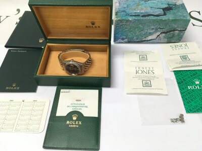 Rolex Datejust 16234 features a vibrant blue dial with Roman numerals. Box and papers. Seen running.