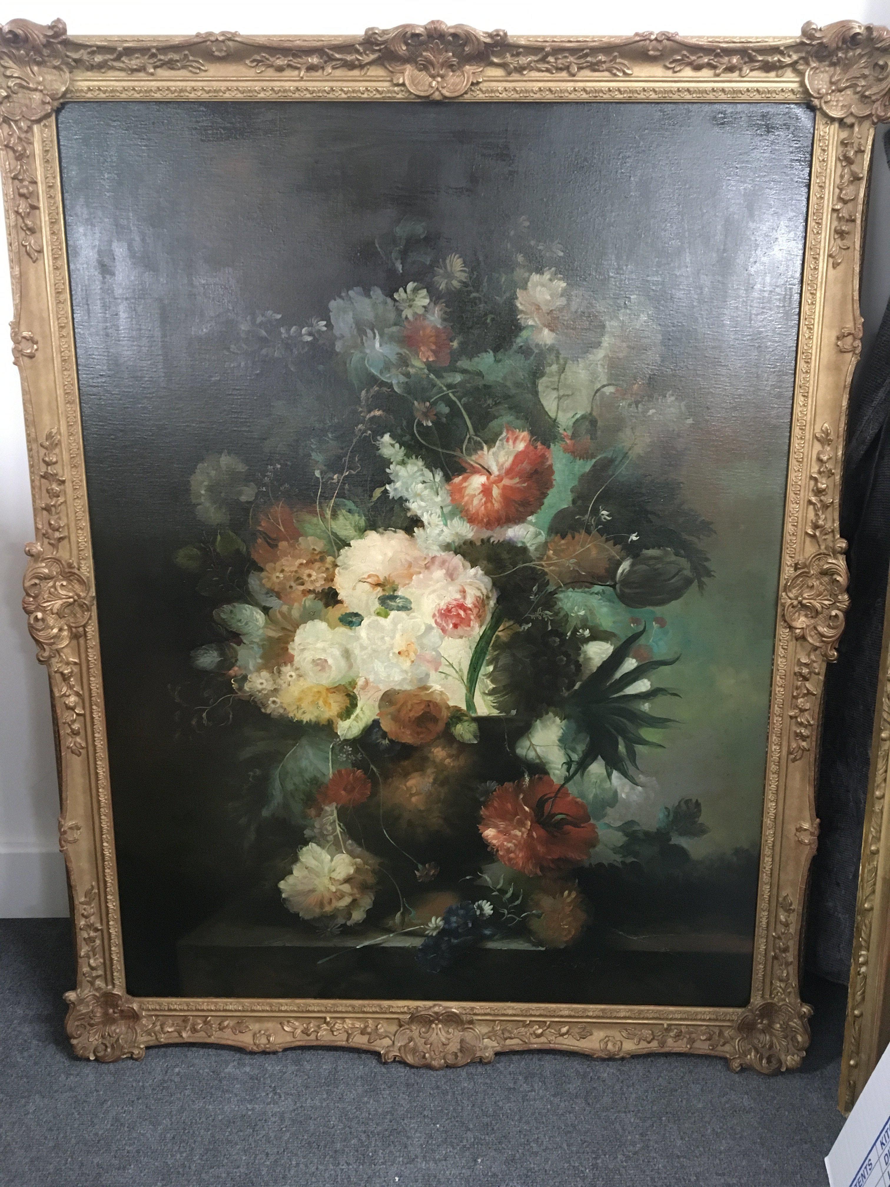 A large gilt framed oil painting on canvas still life study of a profusion of flowers signed by the artist Emillio Greco. 106x136cm