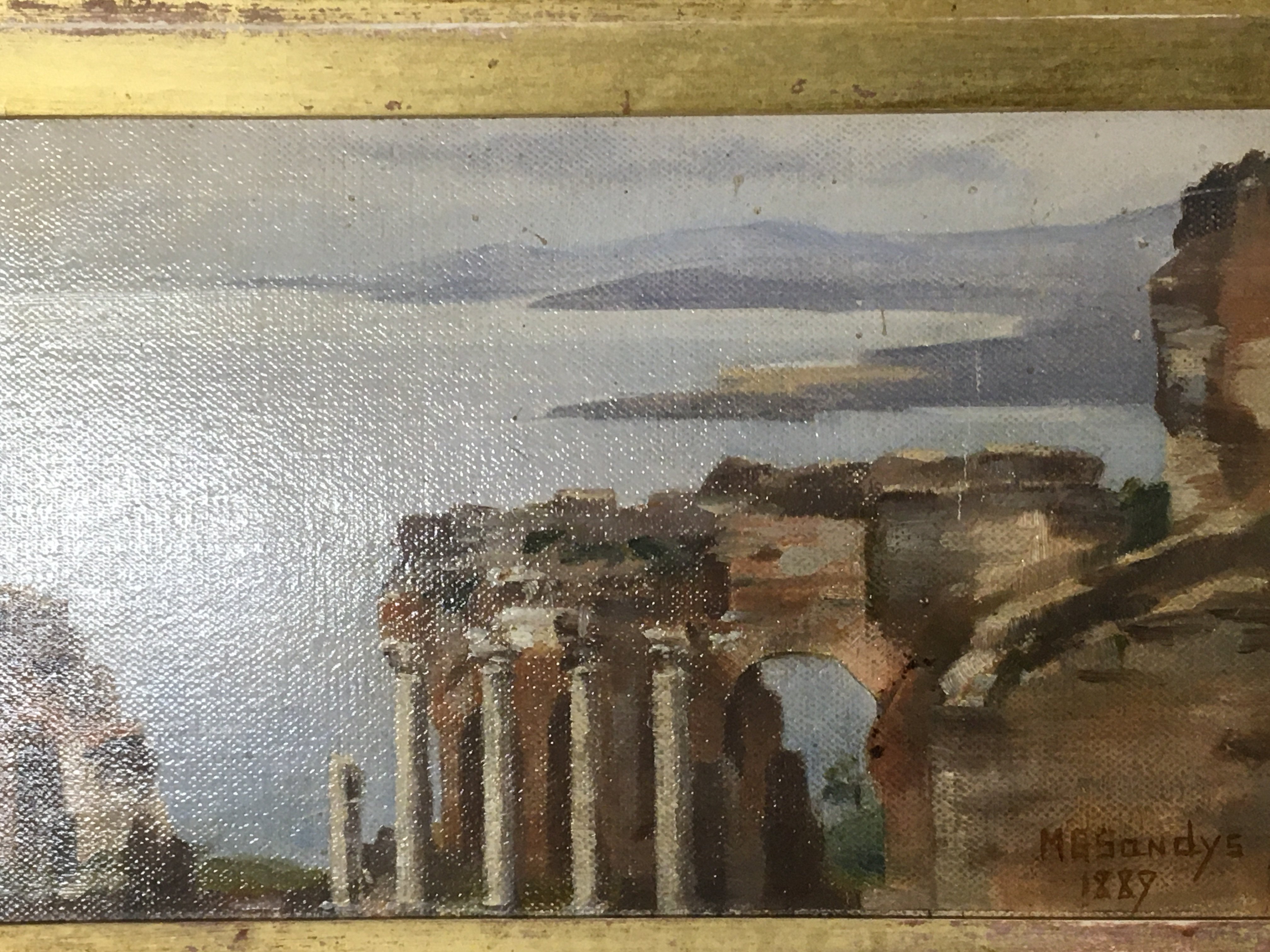 A collection of small oil paintings and 19th century prints and etchings a view of mediterranean coast with ancient ruins signed MG Sandys 1889 a Continental scene on panel and other prints (6)