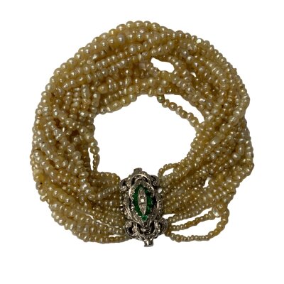 A 1930s multi strand seed pearl bracelet mounted on an 18ct white gold emerald and diamond clasp width 2.5cm