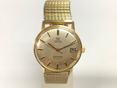 An omega Seamaster vintage watch. Gold vase with aftermarket strap. Winds and runs.
