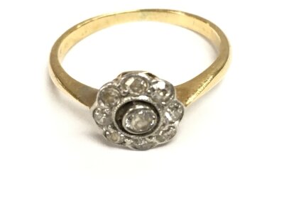 A small unmarked gold and diamond cluster ring. Size J and 1.73g